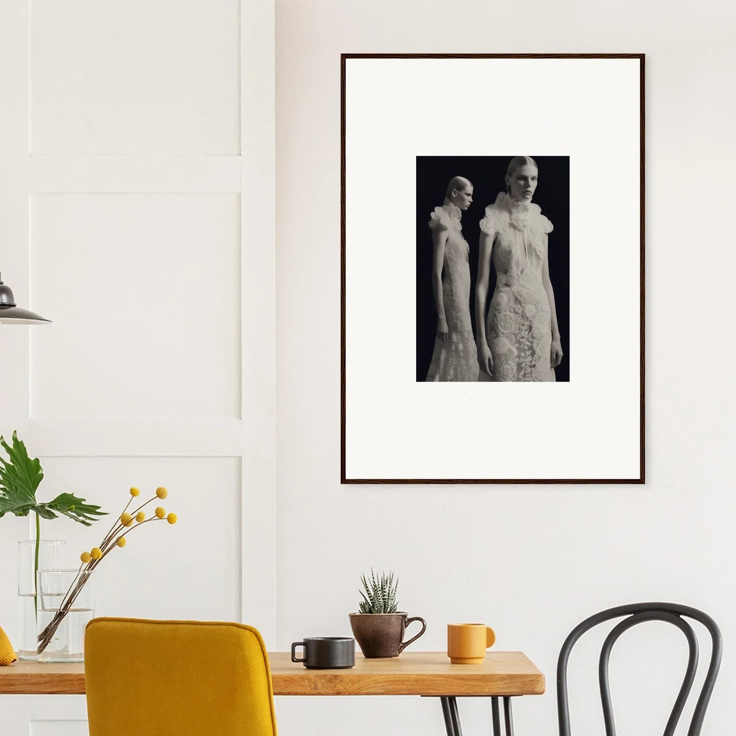 Framed black and white photograph of two figures in elegant attire.