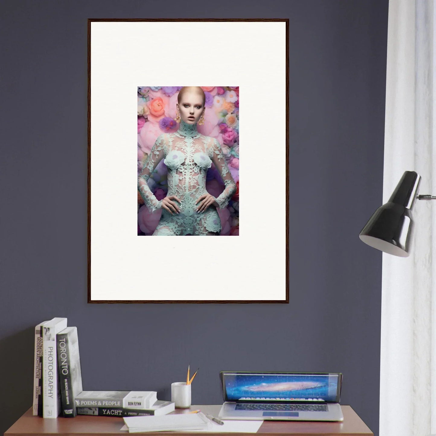 Framed artwork featuring a surreal portrait of a figure in an ornate, pale blue outfit against a dreamy pink and purple background.