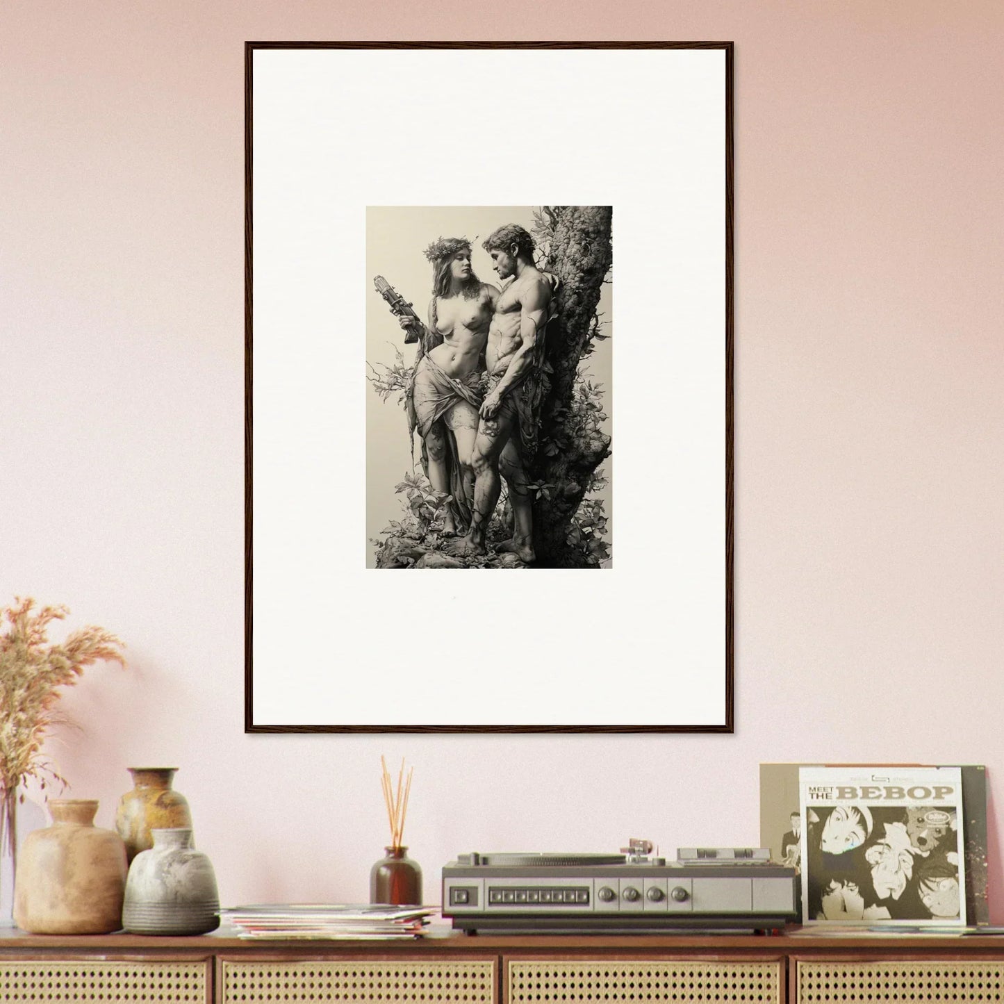 Framed black and white wall art of ethereal entwining nude figures by a tree
