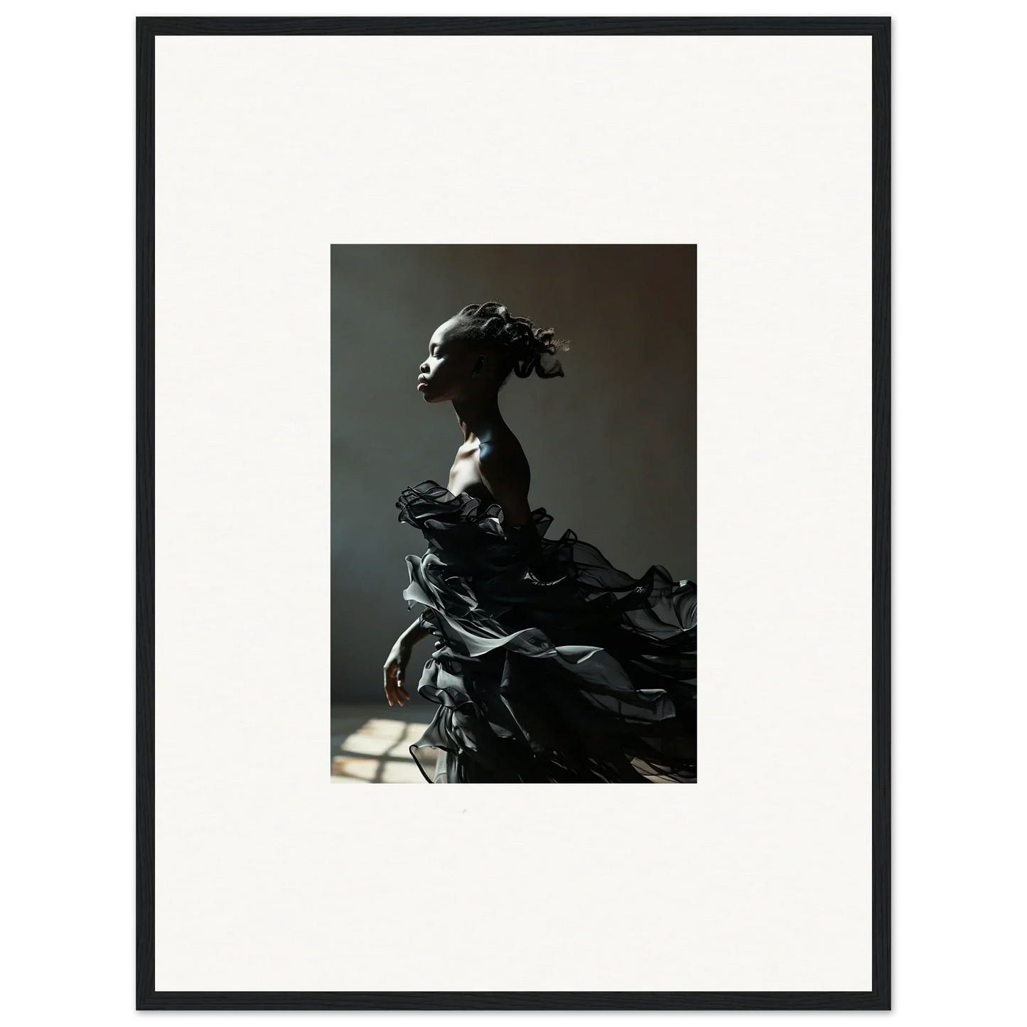 Dramatic black sculpture of a female figure with flowing, layered forms.