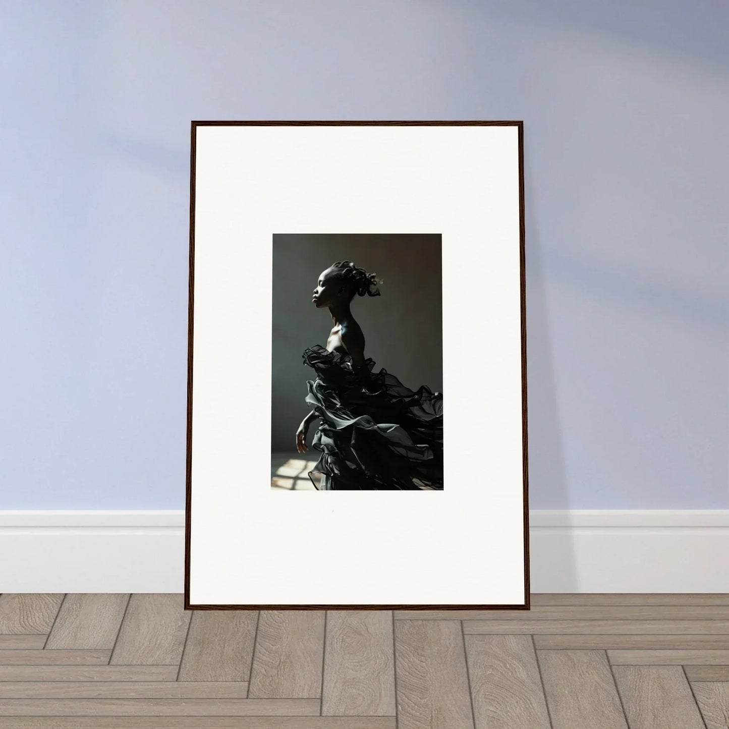 Framed black and white photograph of a figure in elaborate historical costume.