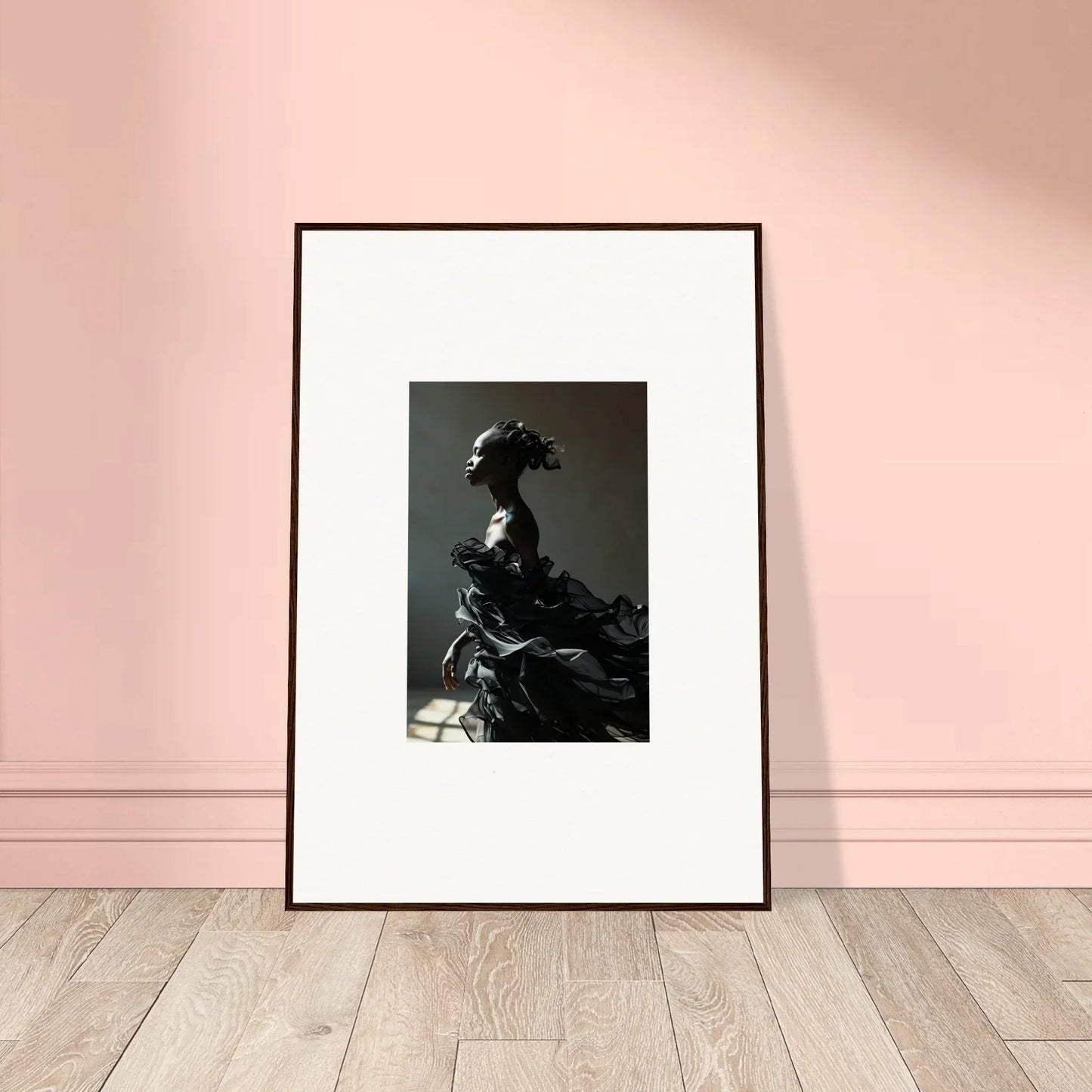 Framed black and white photograph of a person in elaborate historical costume with a dramatic headdress.