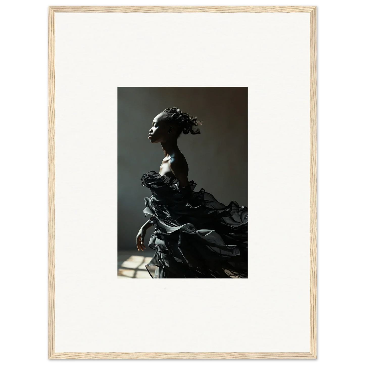 Dramatic black sculpture of a female figure with flowing, billowing forms.