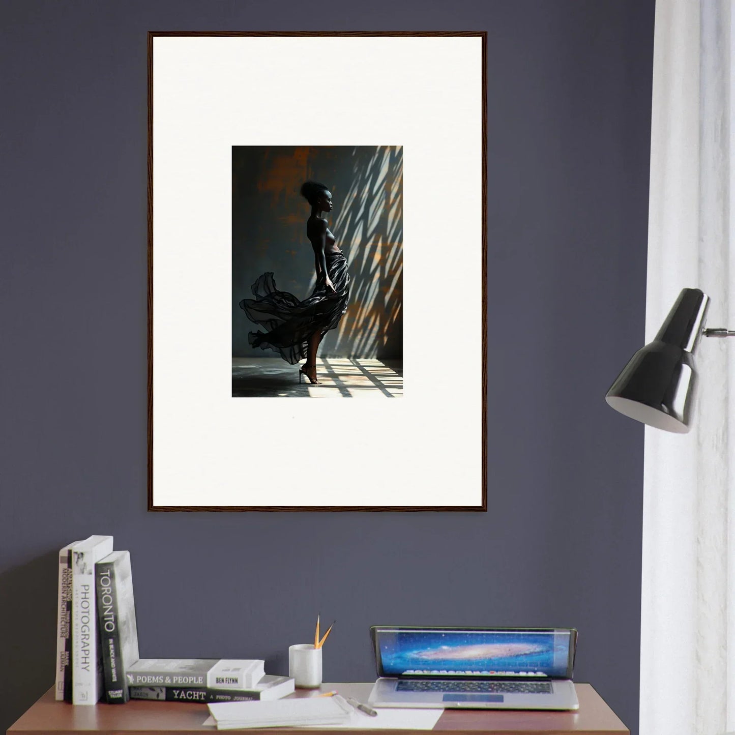 Framed black and white photograph of a silhouetted figure standing in dramatic lighting.