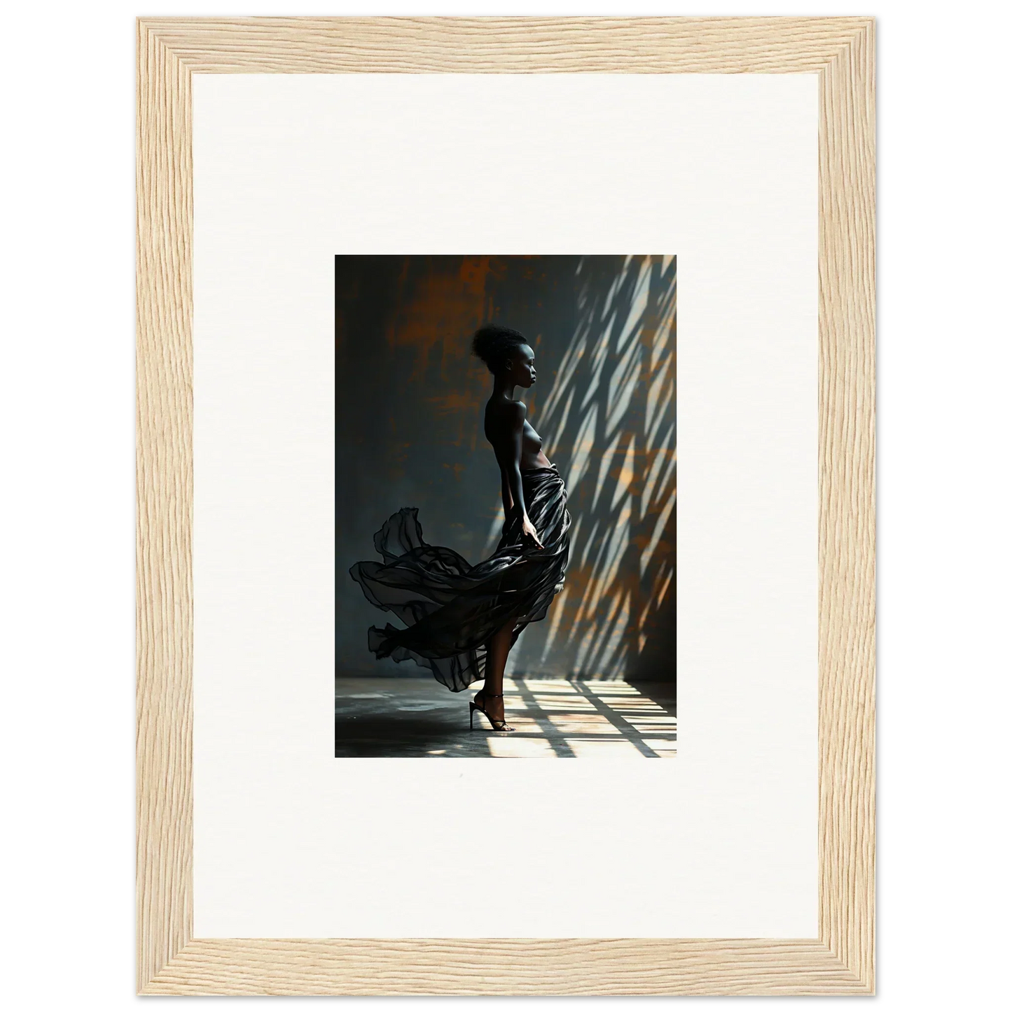 Framed photograph of a silhouetted figure in a flowing dress standing in dramatic lighting.