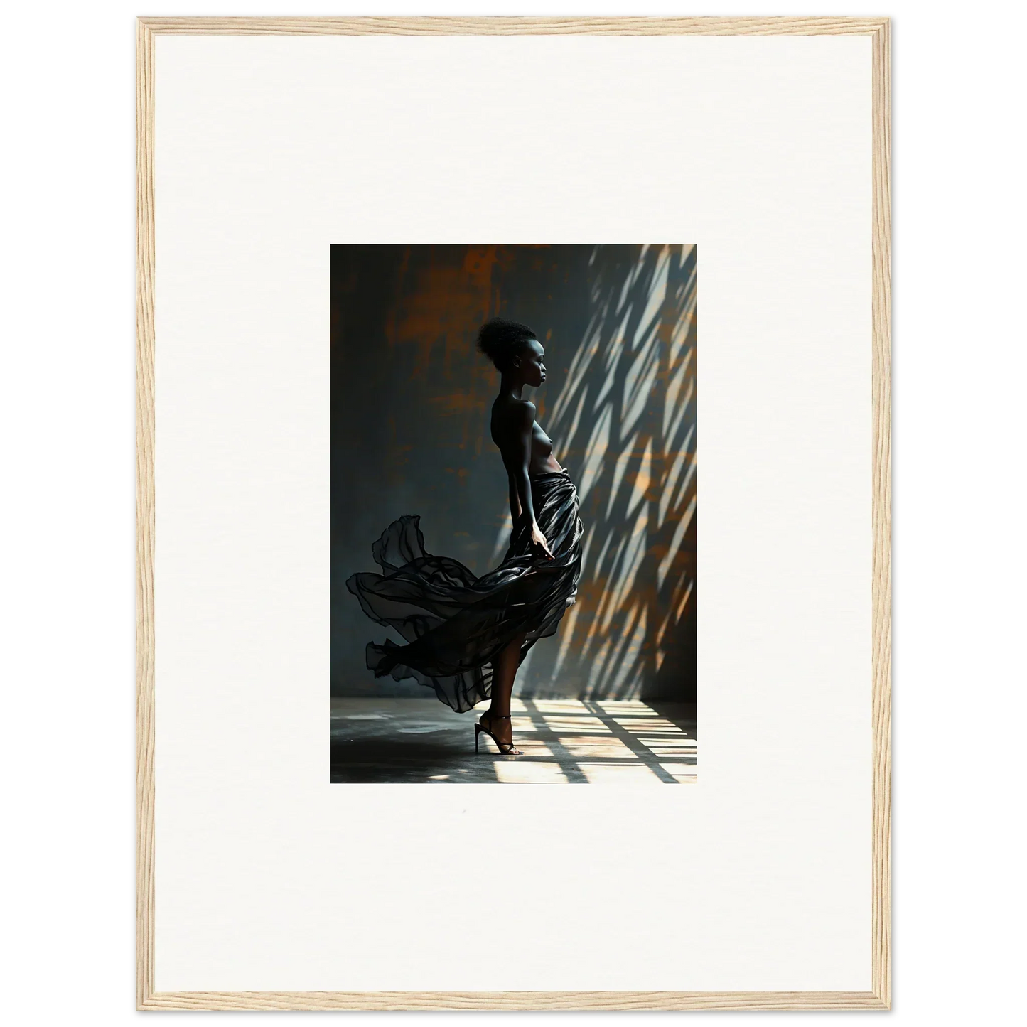 Silhouette of a woman in a flowing dress standing in dramatic lighting.