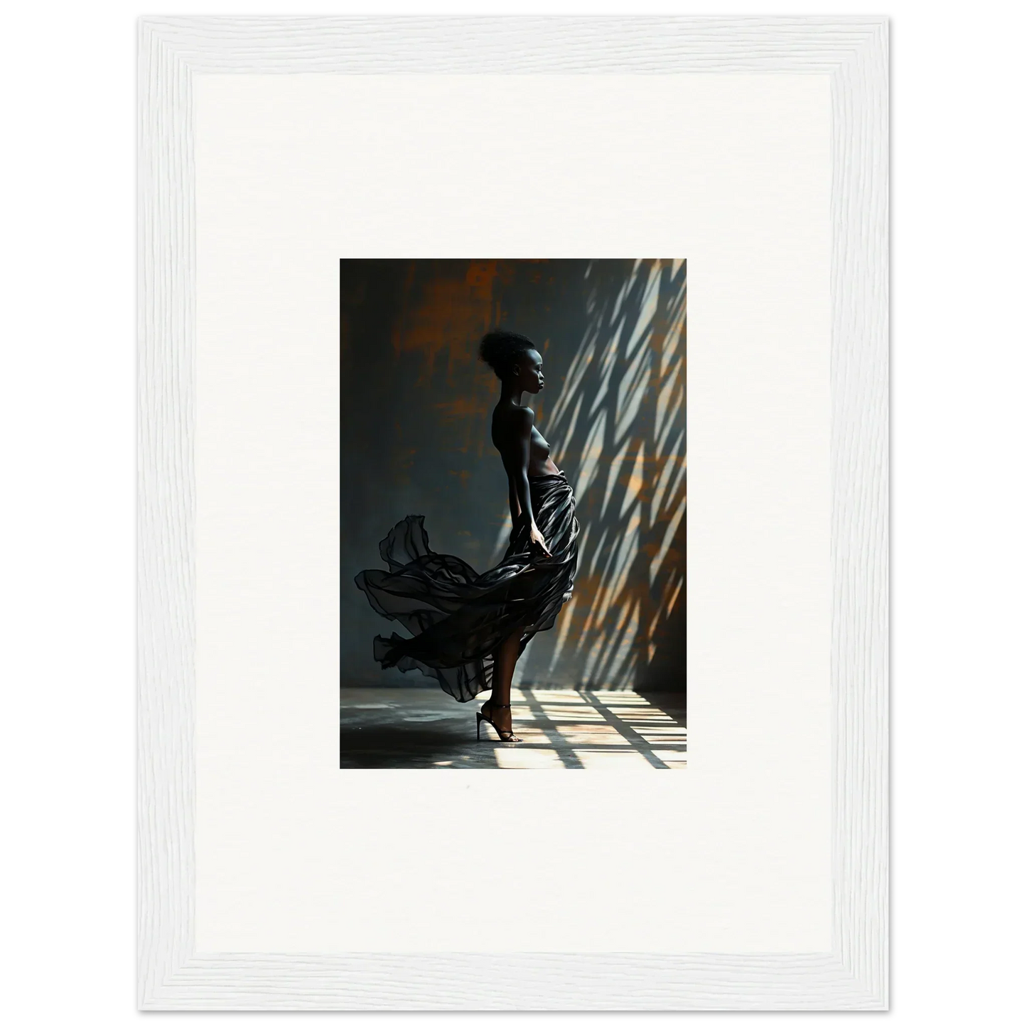 Silhouette of a woman in a flowing dress standing in dramatic lighting.