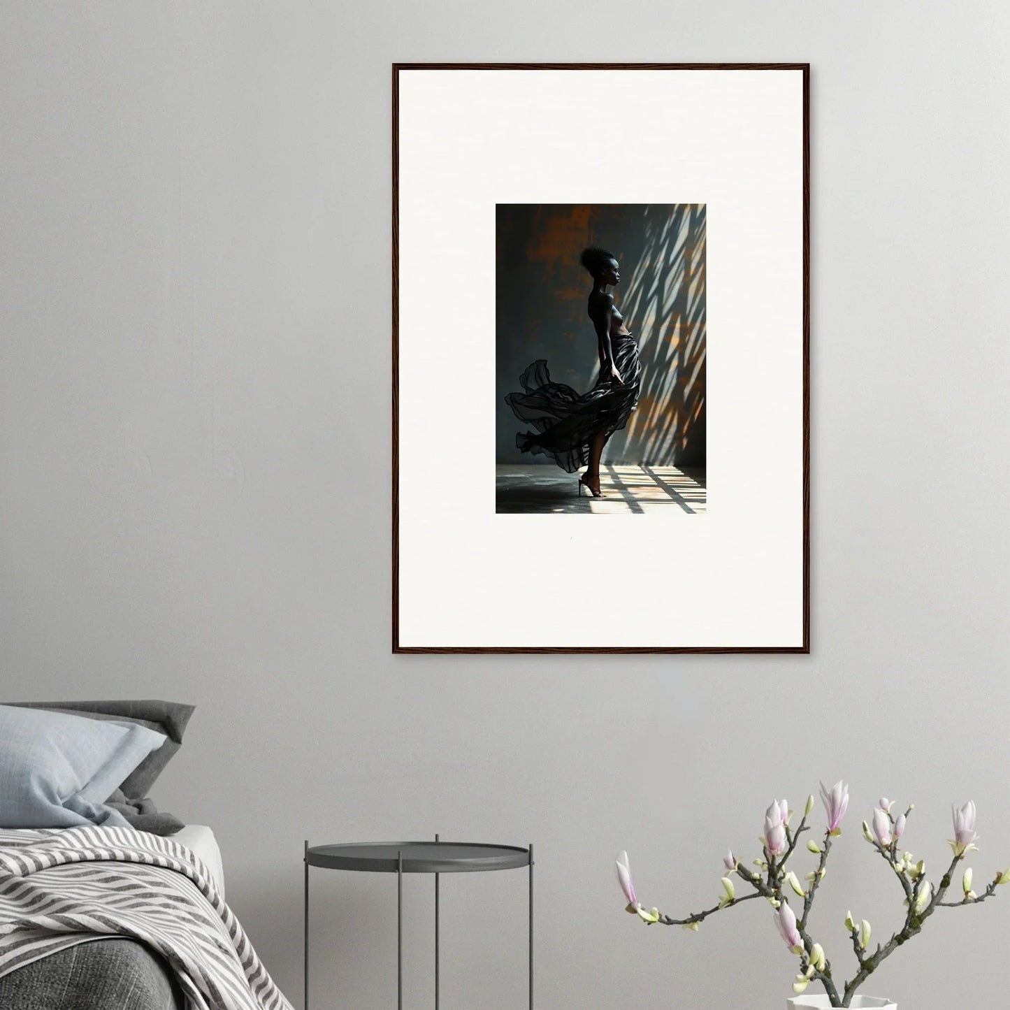 Framed artwork depicting a silhouetted figure standing in dramatic light and shadow.