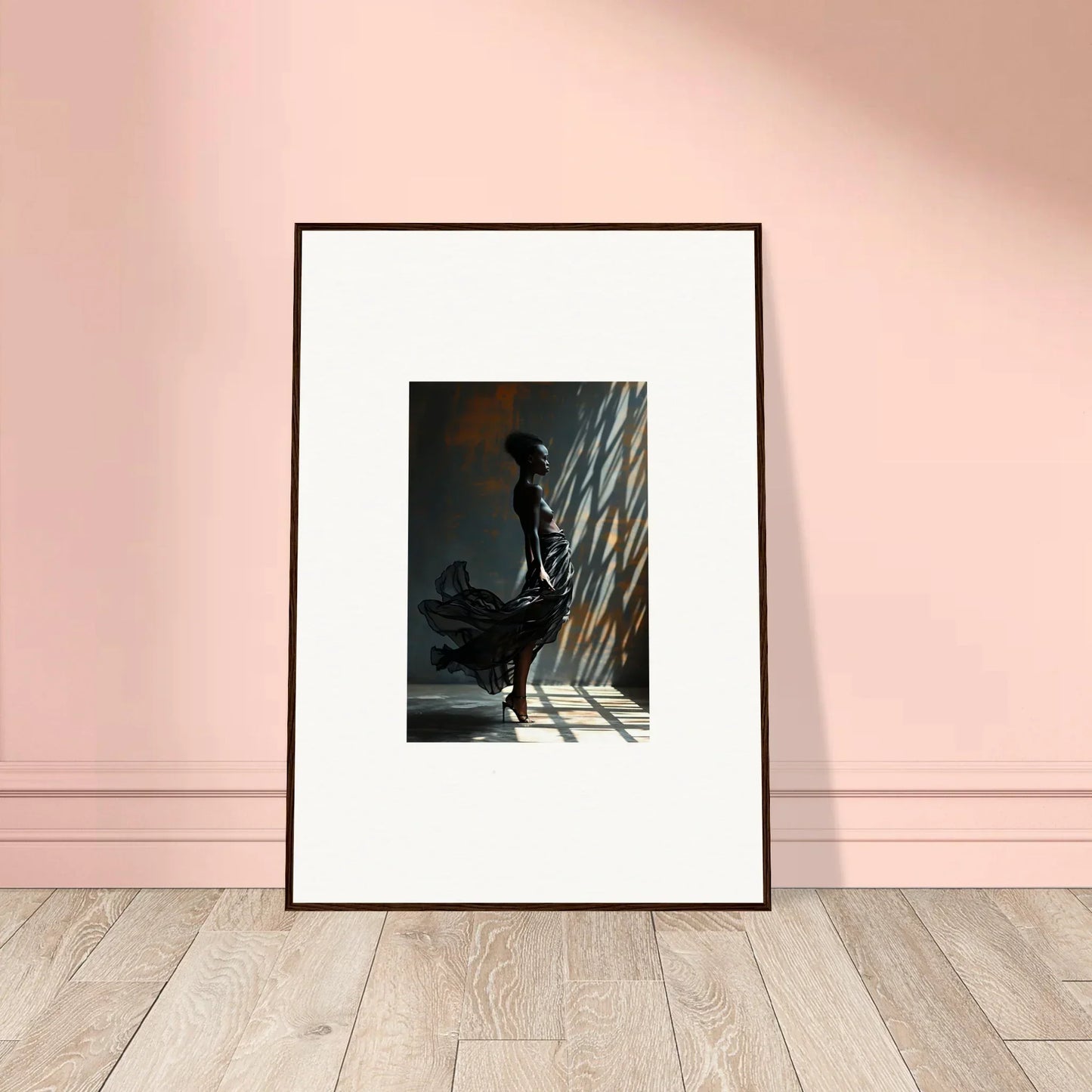 Framed black and white photograph of a silhouetted figure in dramatic lighting.