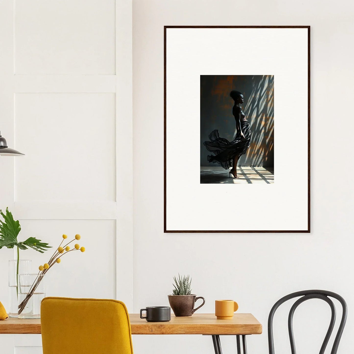 Framed artwork depicting a silhouetted figure in a dramatic, shadowy setting.
