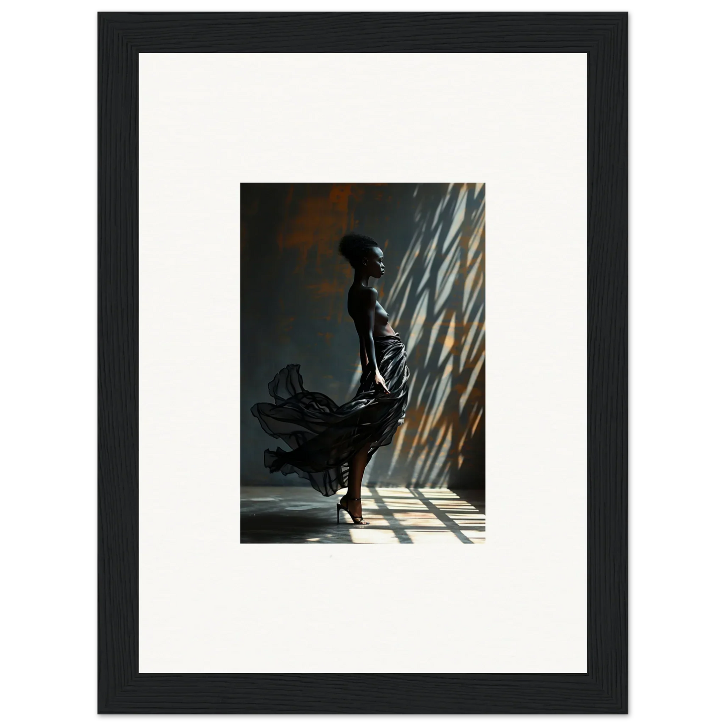 Silhouette of a person in a flowing dress standing in dramatic lighting.