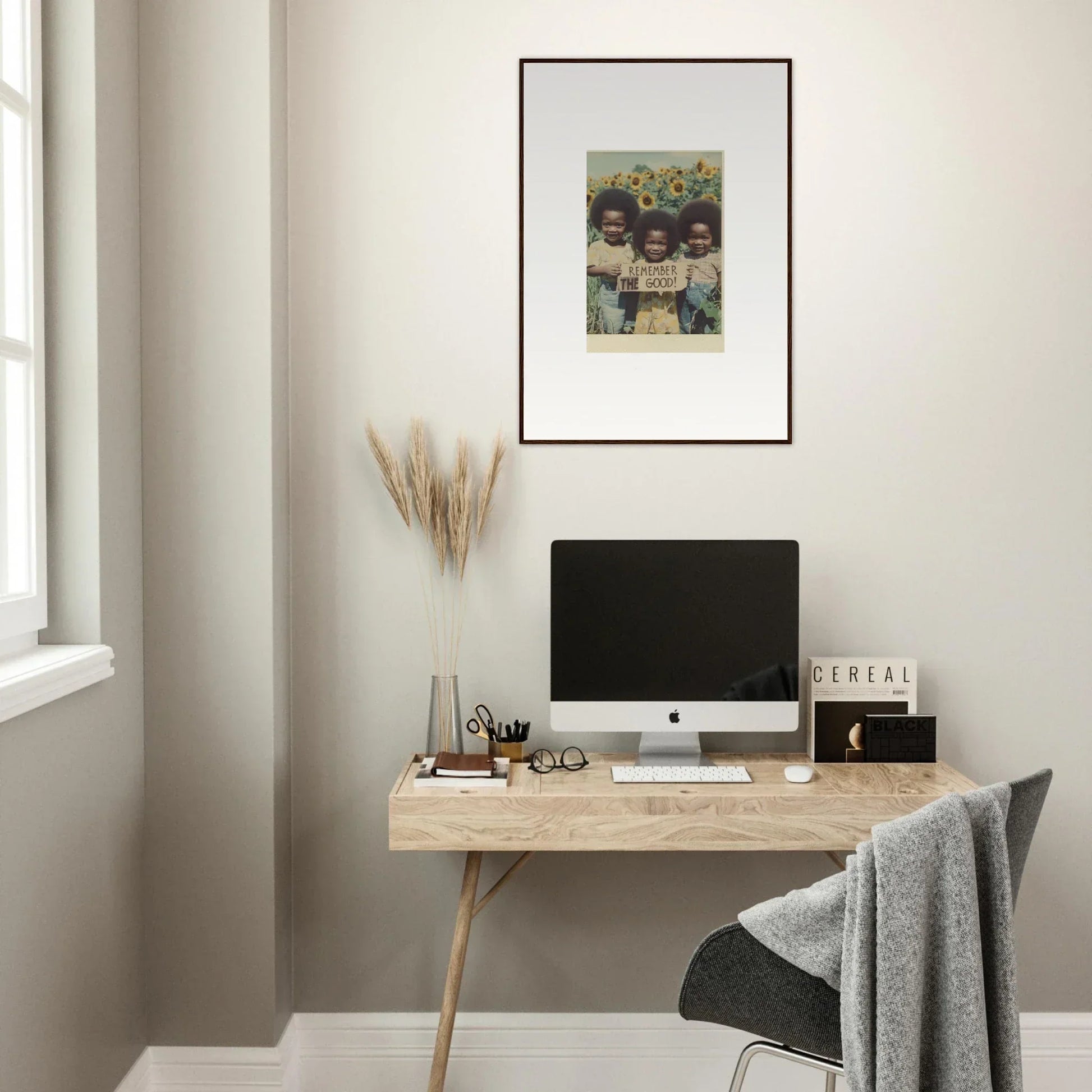 Minimalist wooden desk with a computer and canvas print for perfect bloom moments decor