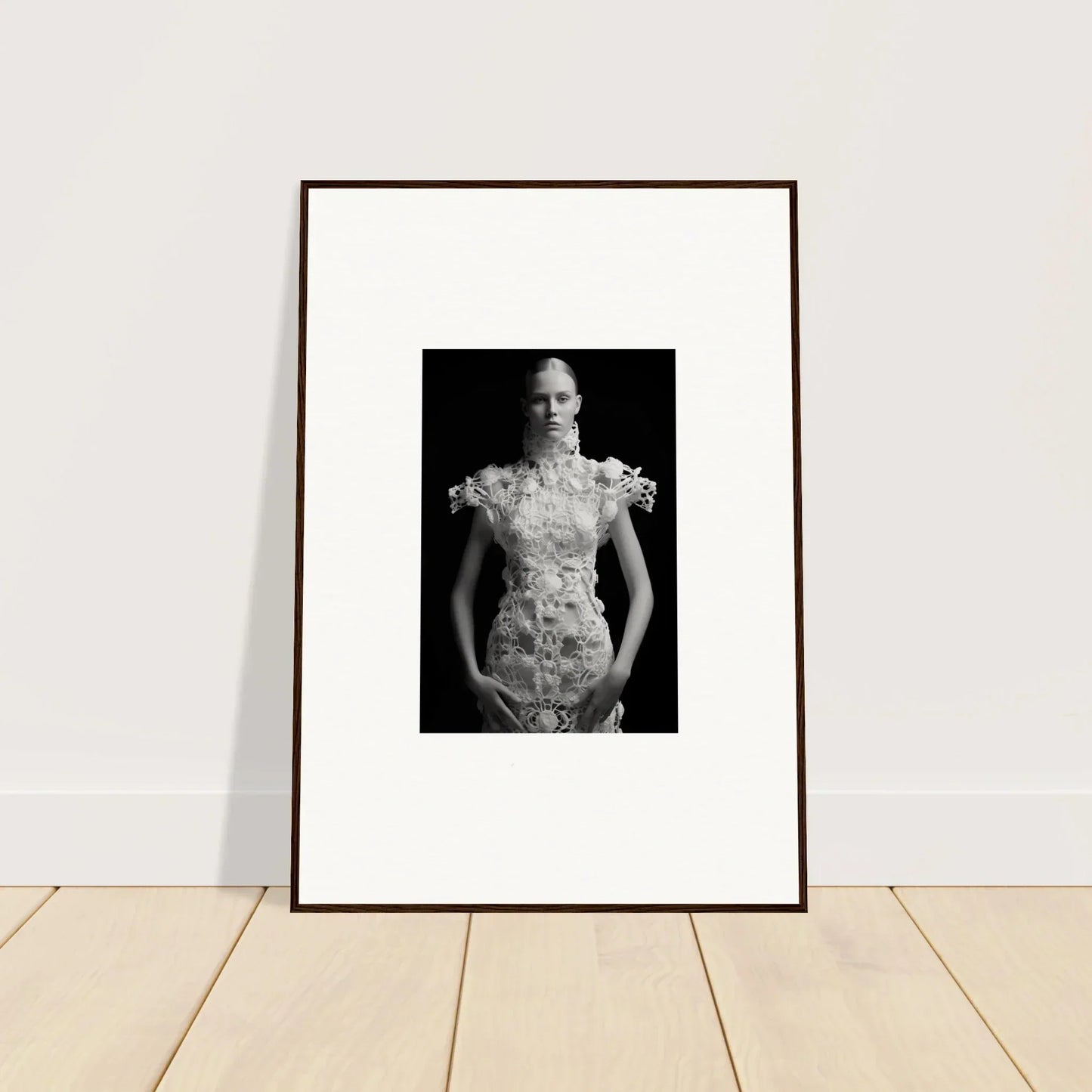 Framed black and white wall art featuring a person in an elaborate floral dress for room decor