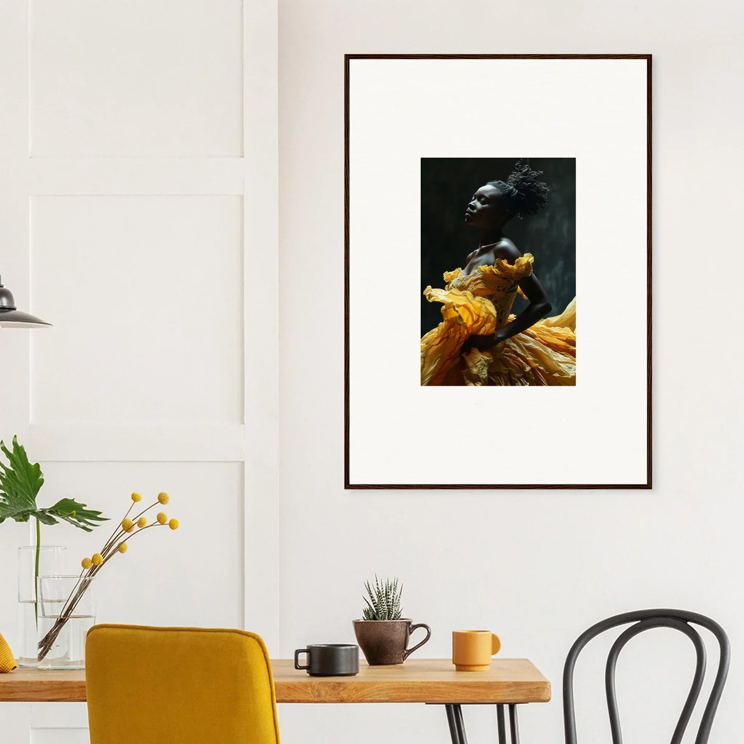 Framed artwork depicting a figure in dramatic yellow and orange drapery against a dark background.
