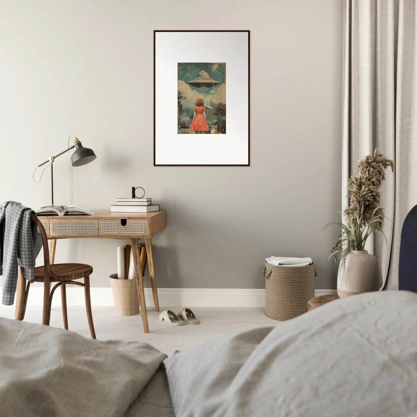 Framed wall art of a figure in a red dress facing a UFO in surreal room decor