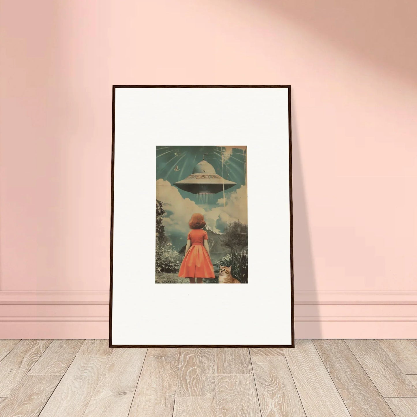 Framed wall art of a figure in a red dress facing a UFO in surreal room decor