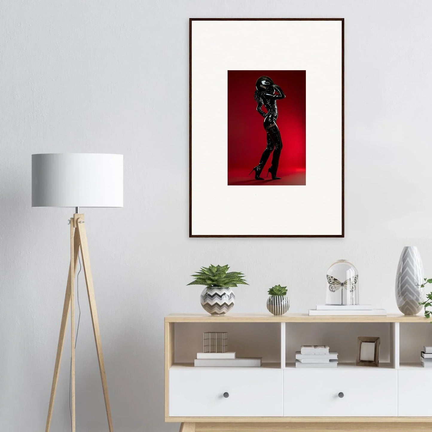 Framed artwork depicting a silhouetted figure against a red background.