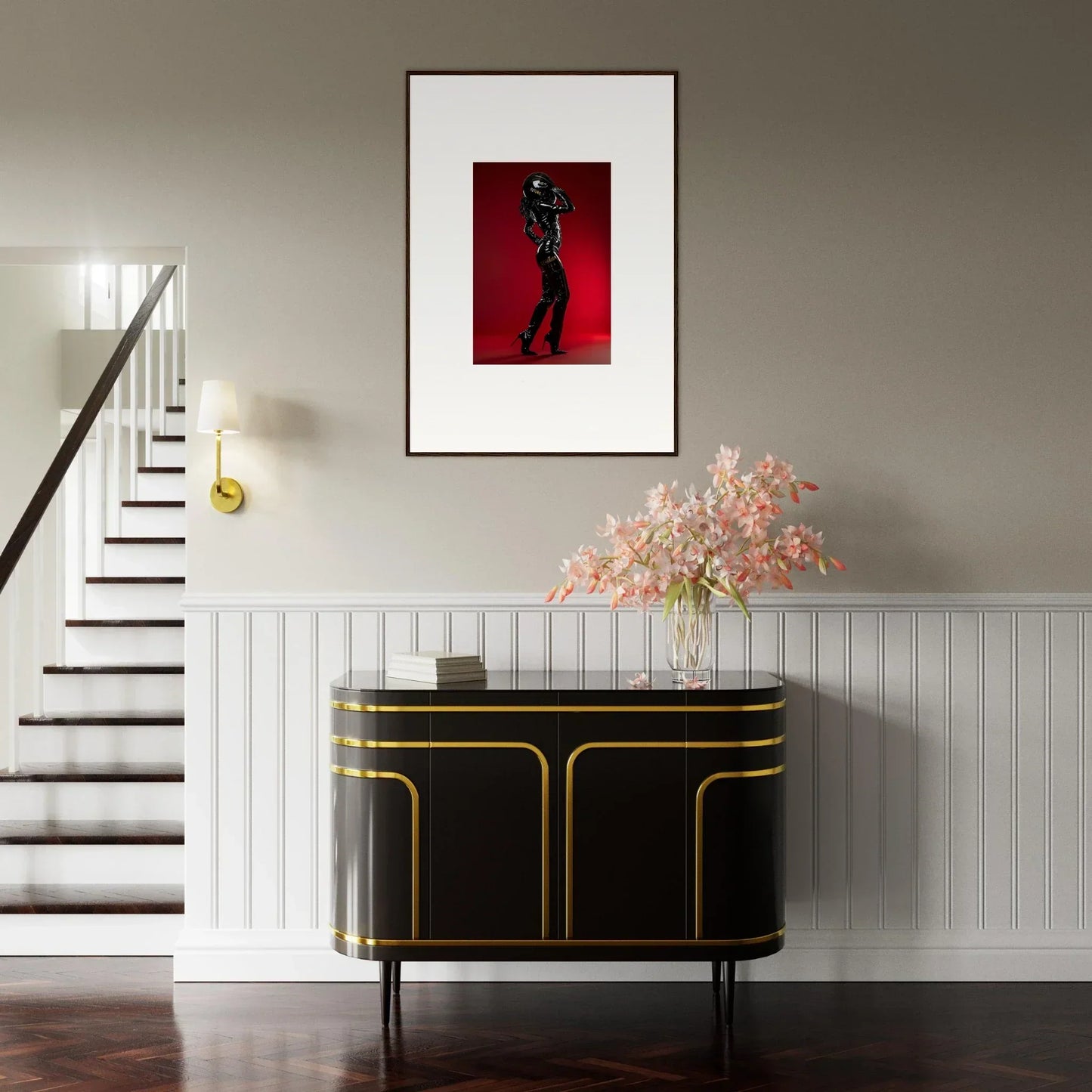 Elegant black and gold sideboard with curved edges beneath a framed artwork.