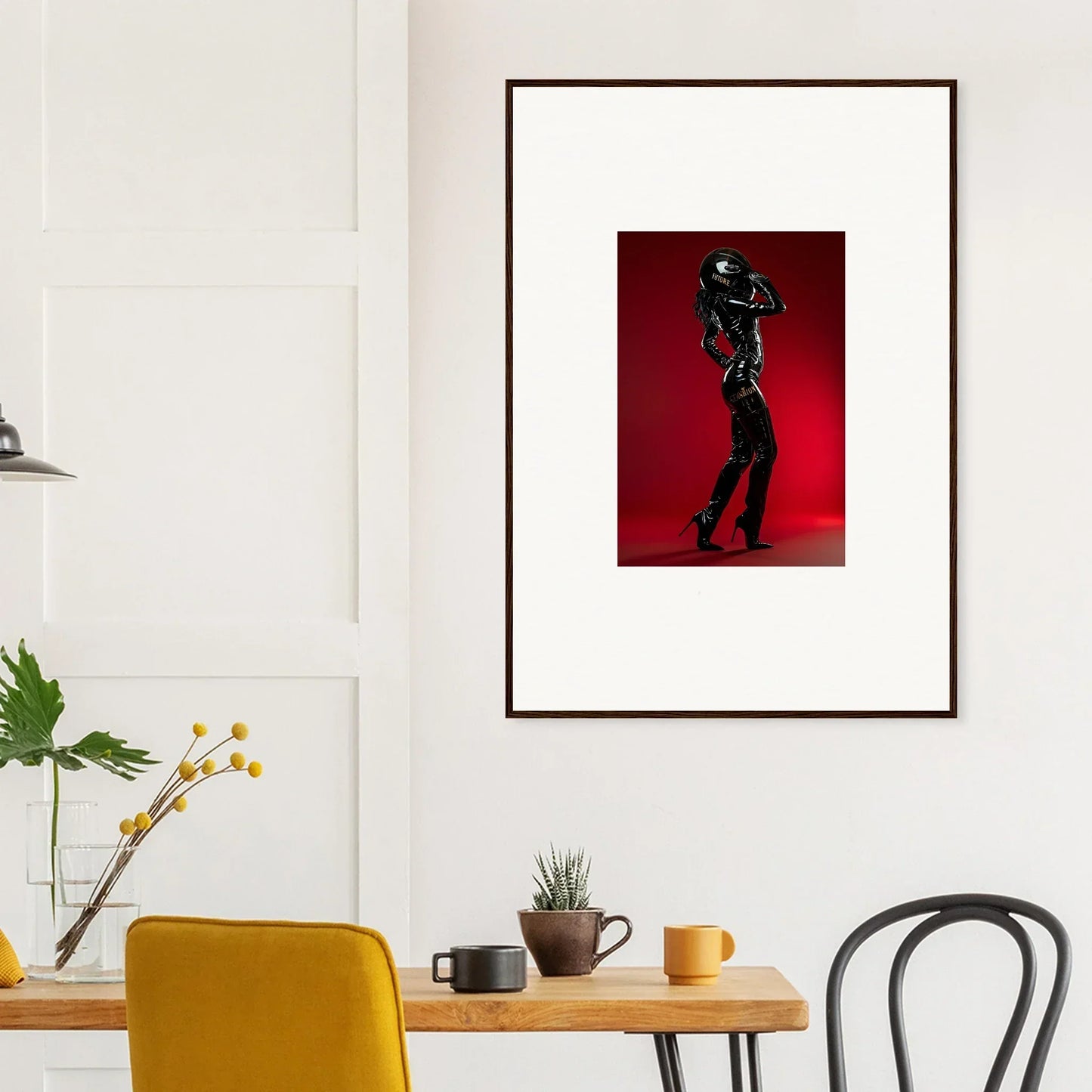 Framed artwork depicting a silhouetted figure dancing against a red background.