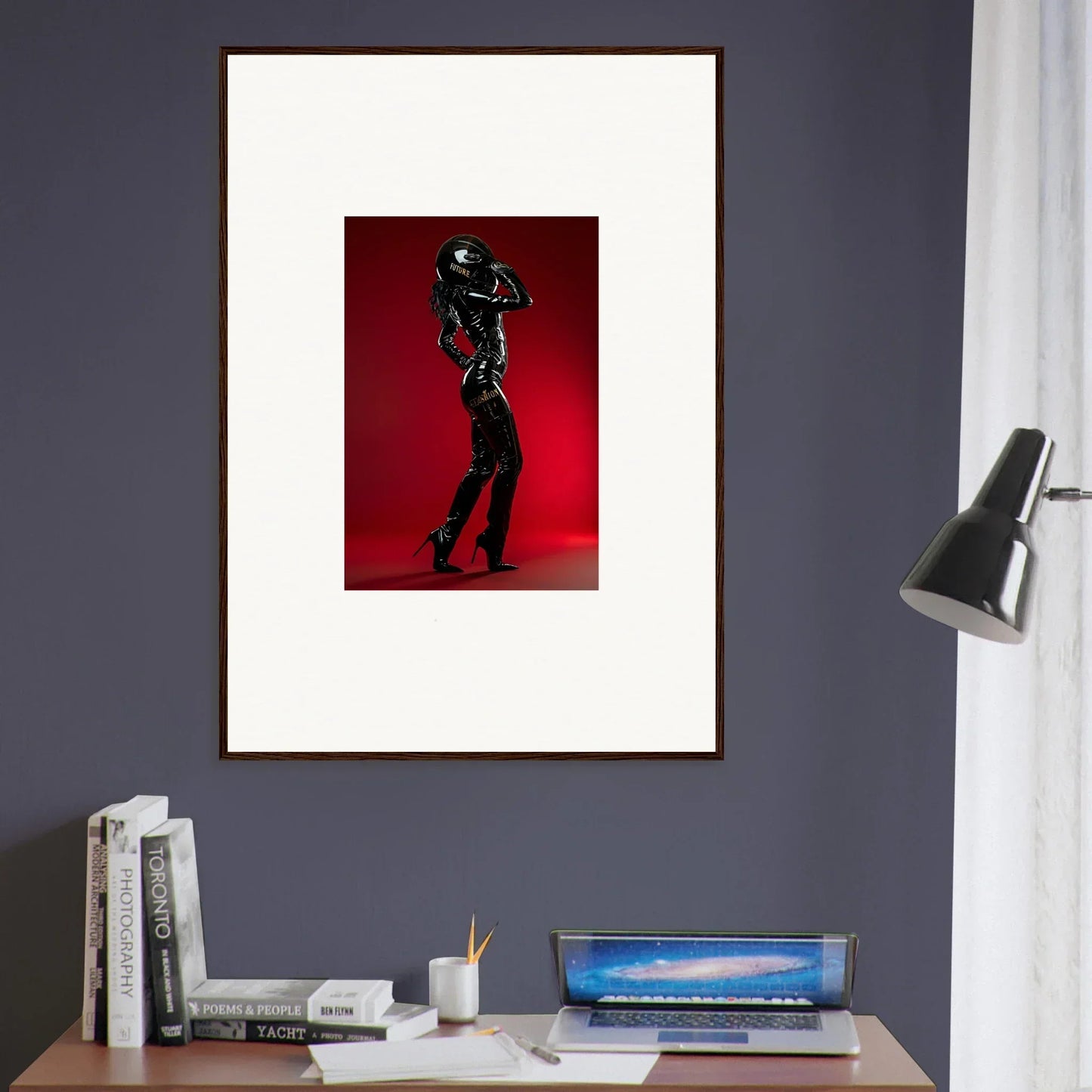 Framed artwork depicting a silhouetted figure in a dynamic pose against a red background.