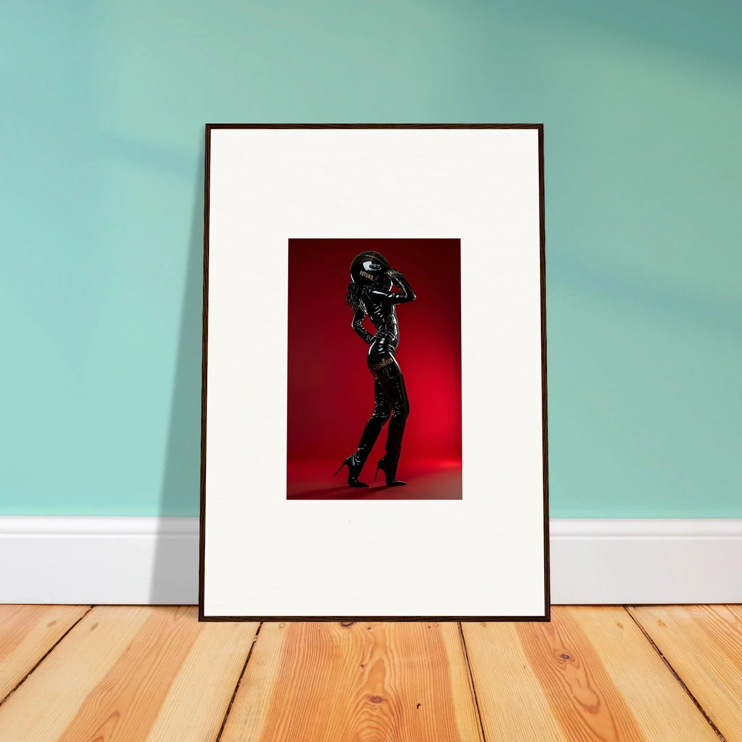 Framed photograph of a silhouetted figure holding a football helmet against a red background.