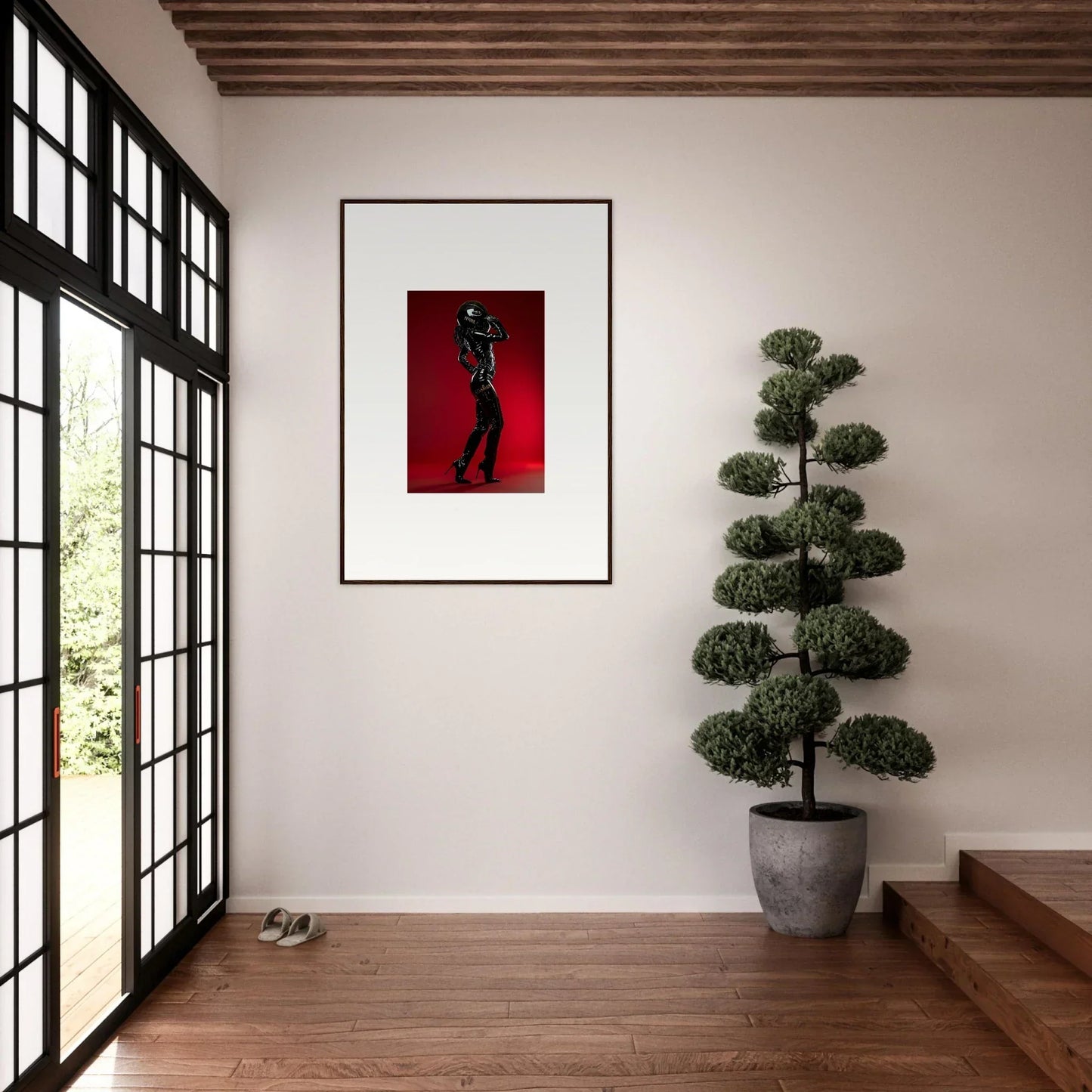 Framed artwork depicting a silhouetted figure against a red background.