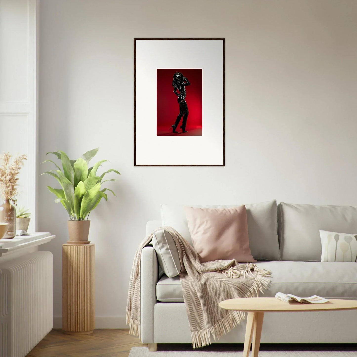 Framed artwork depicting a silhouetted figure against a red background.