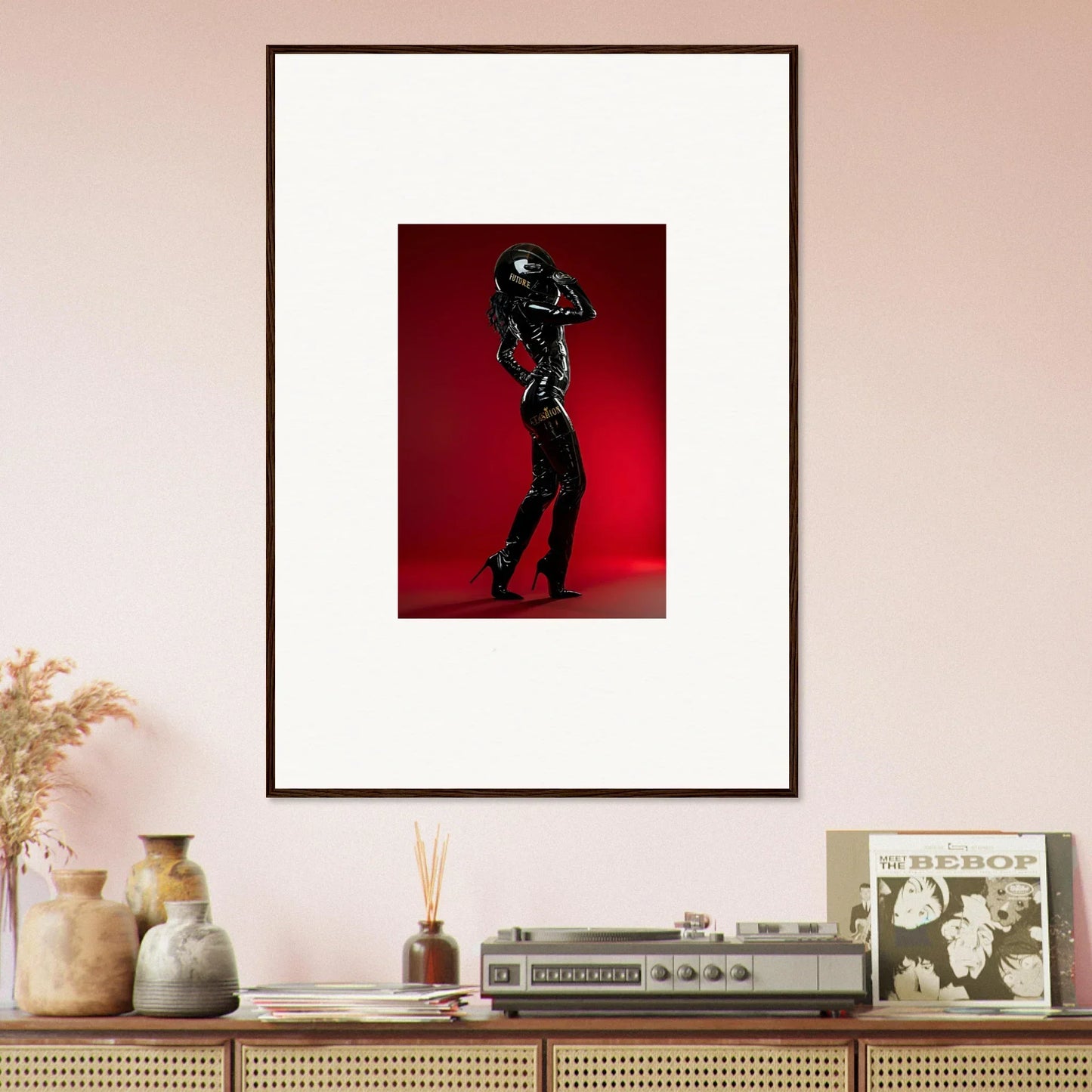 Framed photograph of a silhouetted figure in a dynamic pose against a red background.