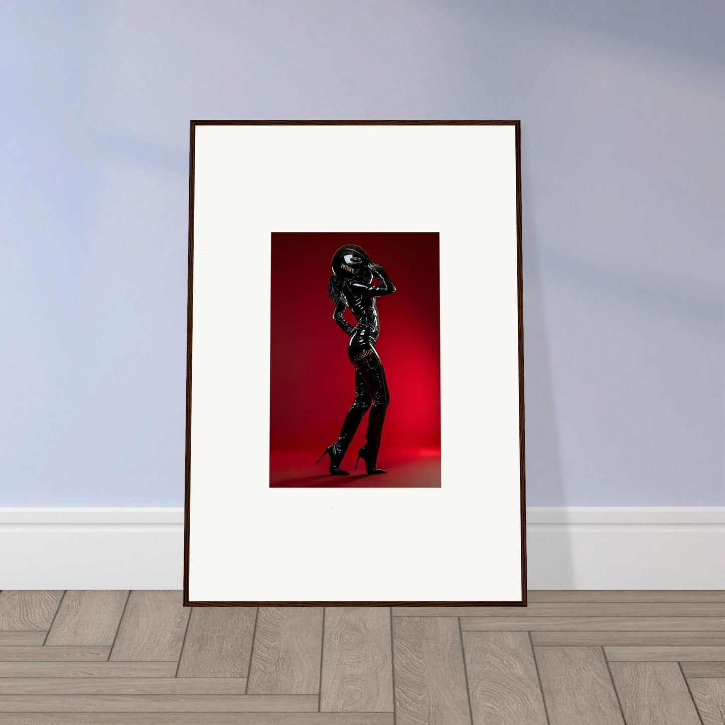 Framed artwork depicting a silhouetted figure dancing against a red background.