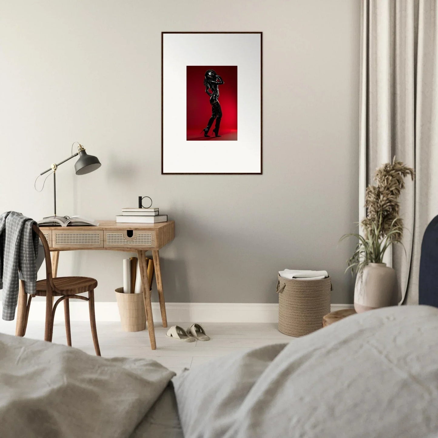 Framed artwork depicting a silhouetted figure on a red background.
