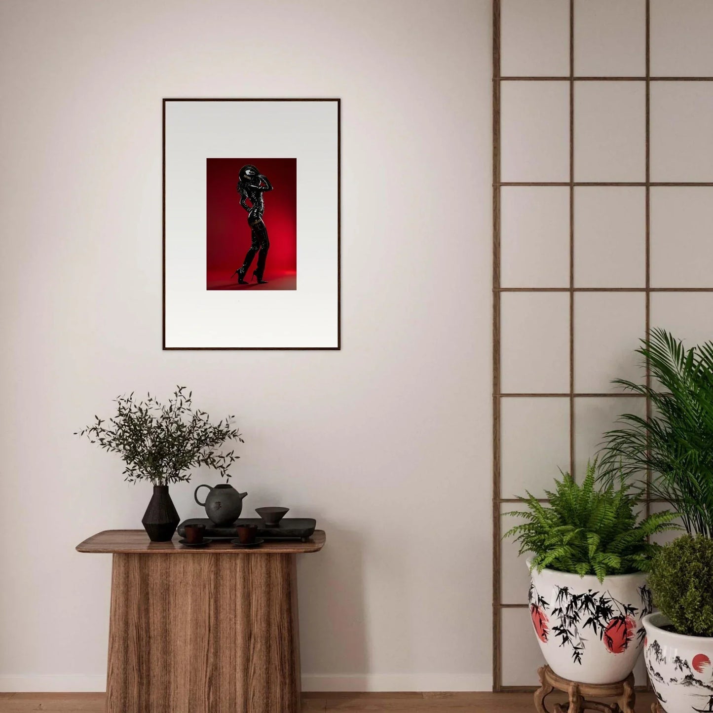 Framed artwork depicting a silhouetted figure on a red background.