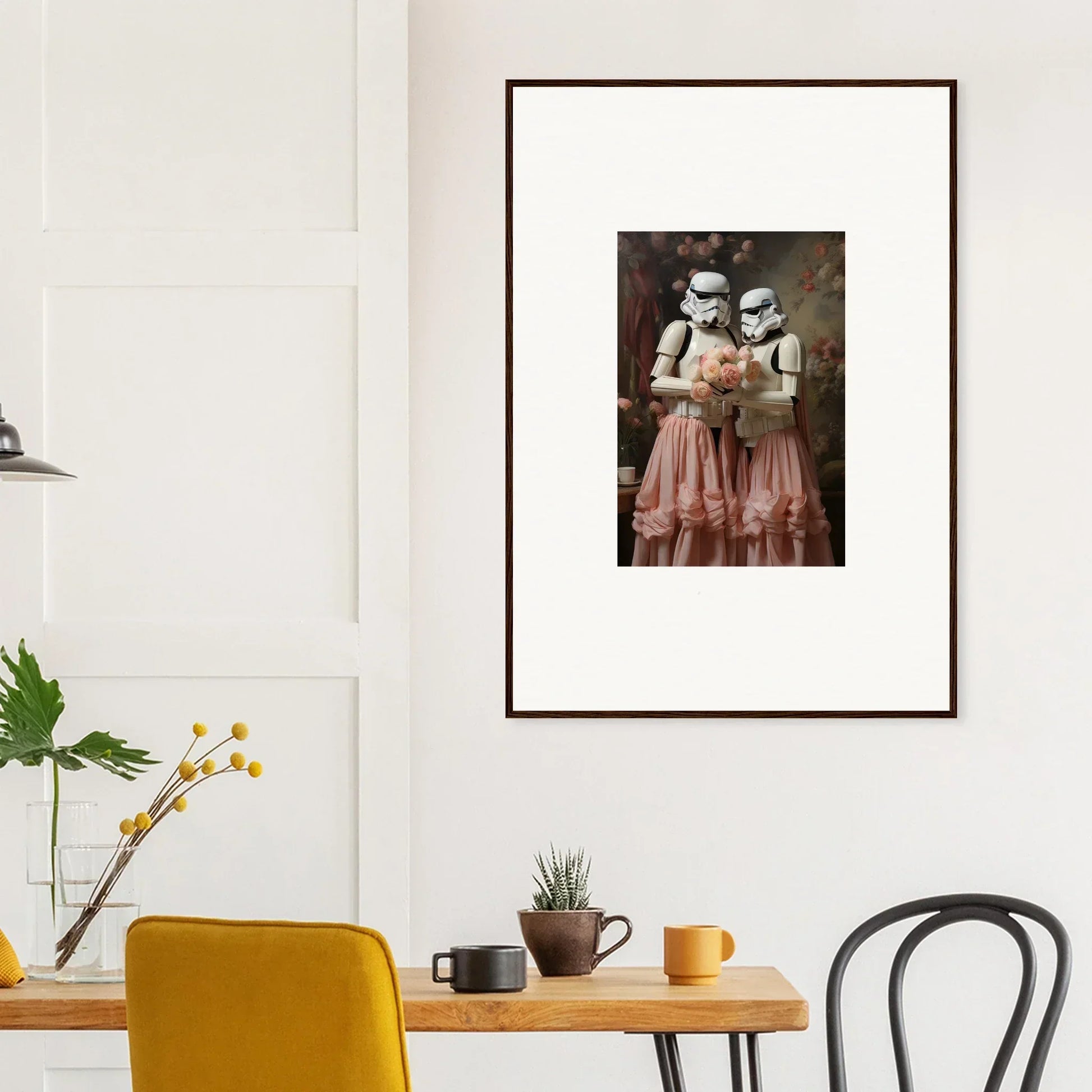 Framed artwork depicting two figures in Stormtrooper helmets wearing pink dresses.