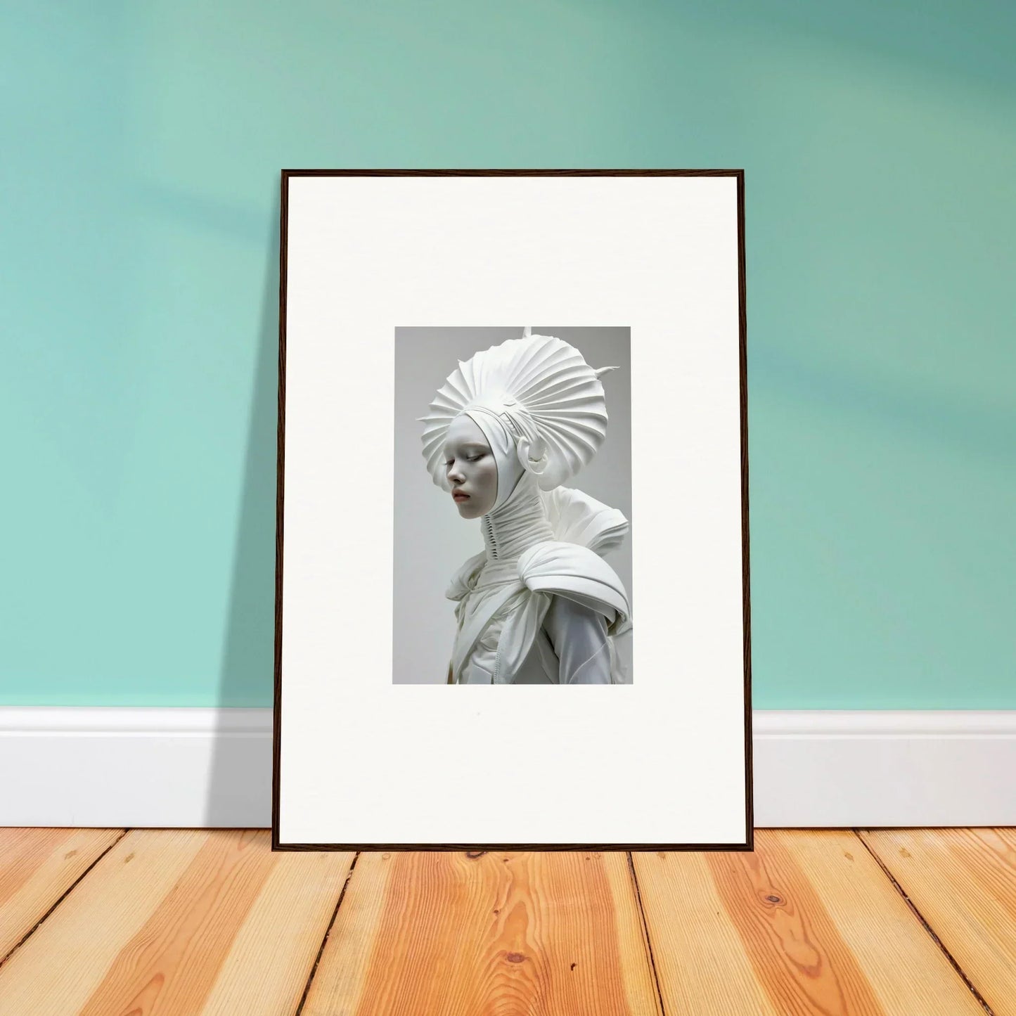 Framed black and white wall art of person in elaborate headdress with ivory halos