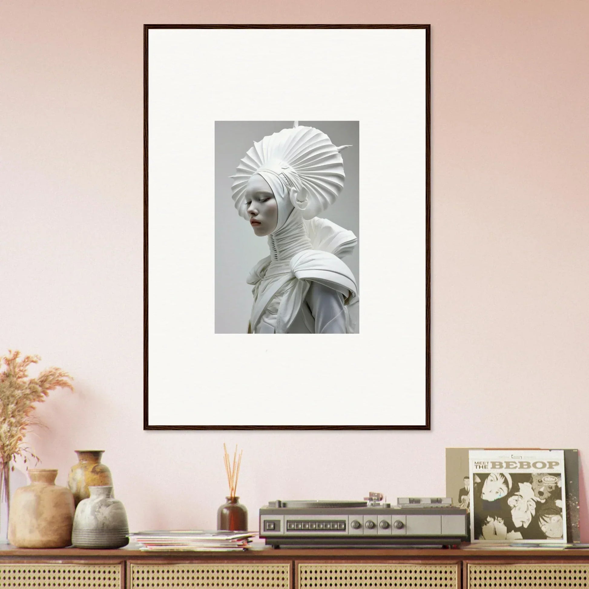 Framed wall art of a figure in an elaborate white headdress with ivory halos