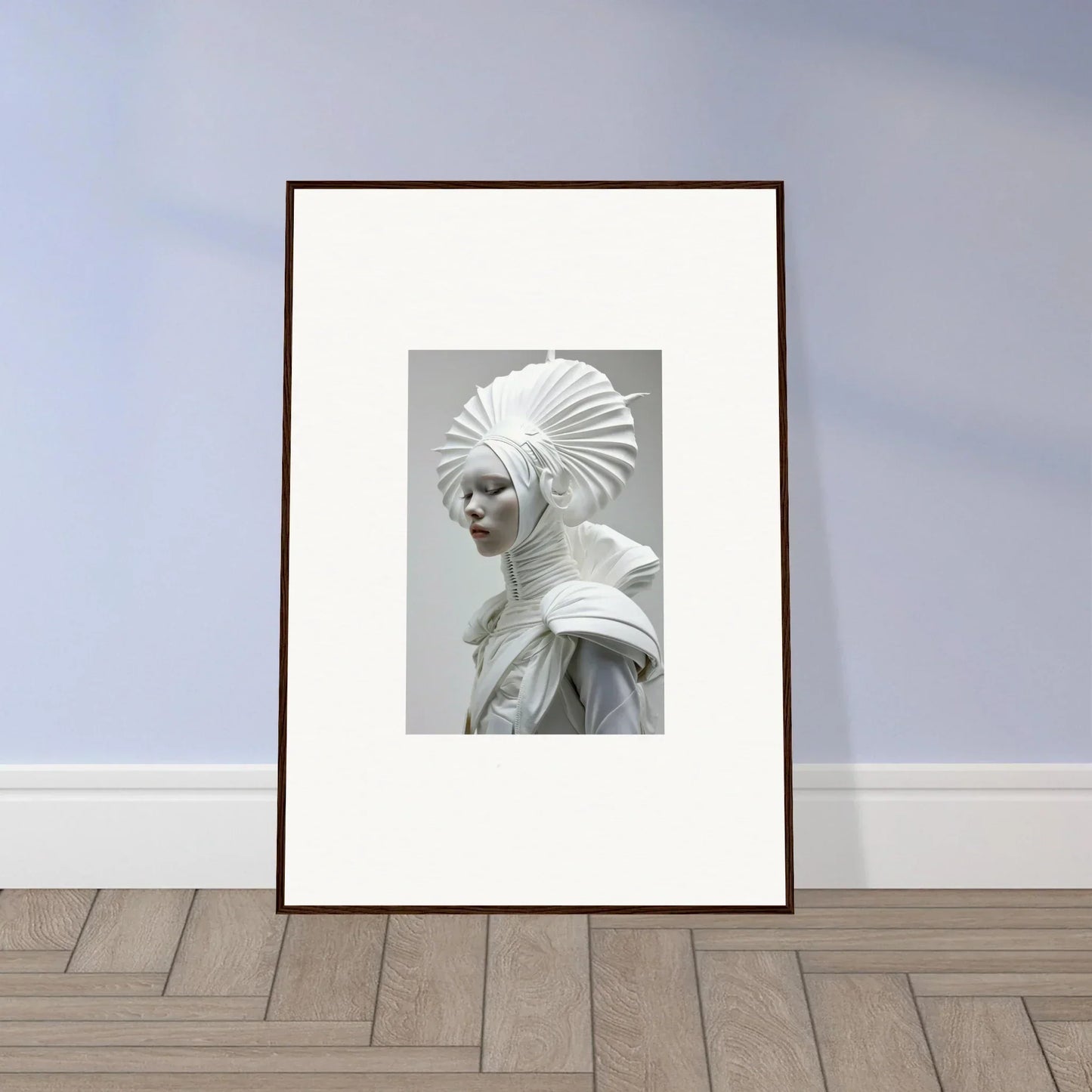 Framed black-and-white wall art of a figure in an elaborate headdress with ivory halos