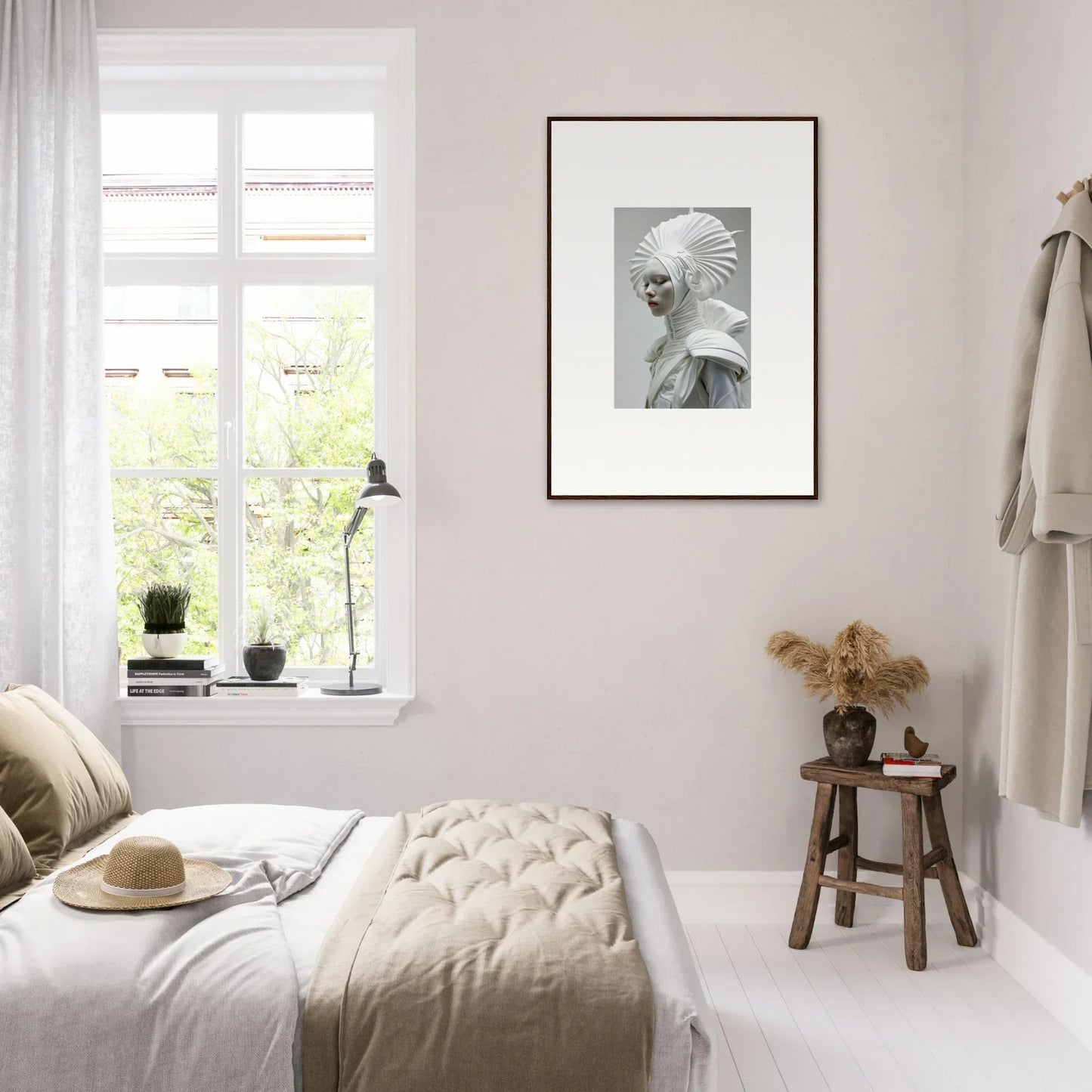 Bright minimalist bedroom with white walls, bedding, and stylish ivory halos room decor