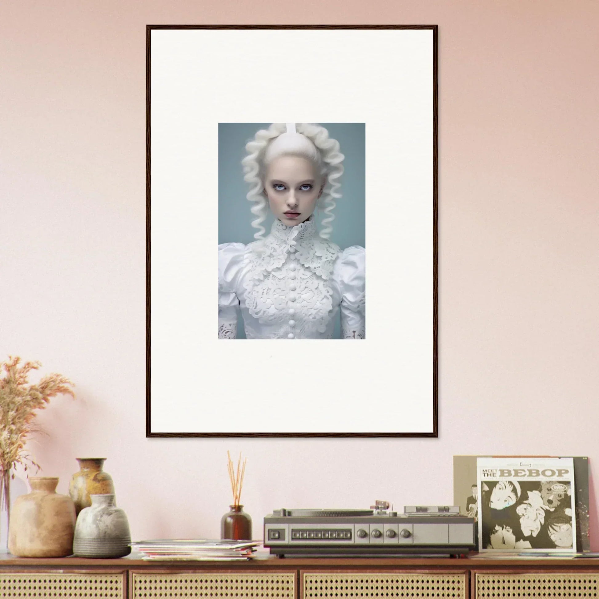 Framed portrait of a person with white hair and pale makeup wearing an ornate white outfit.