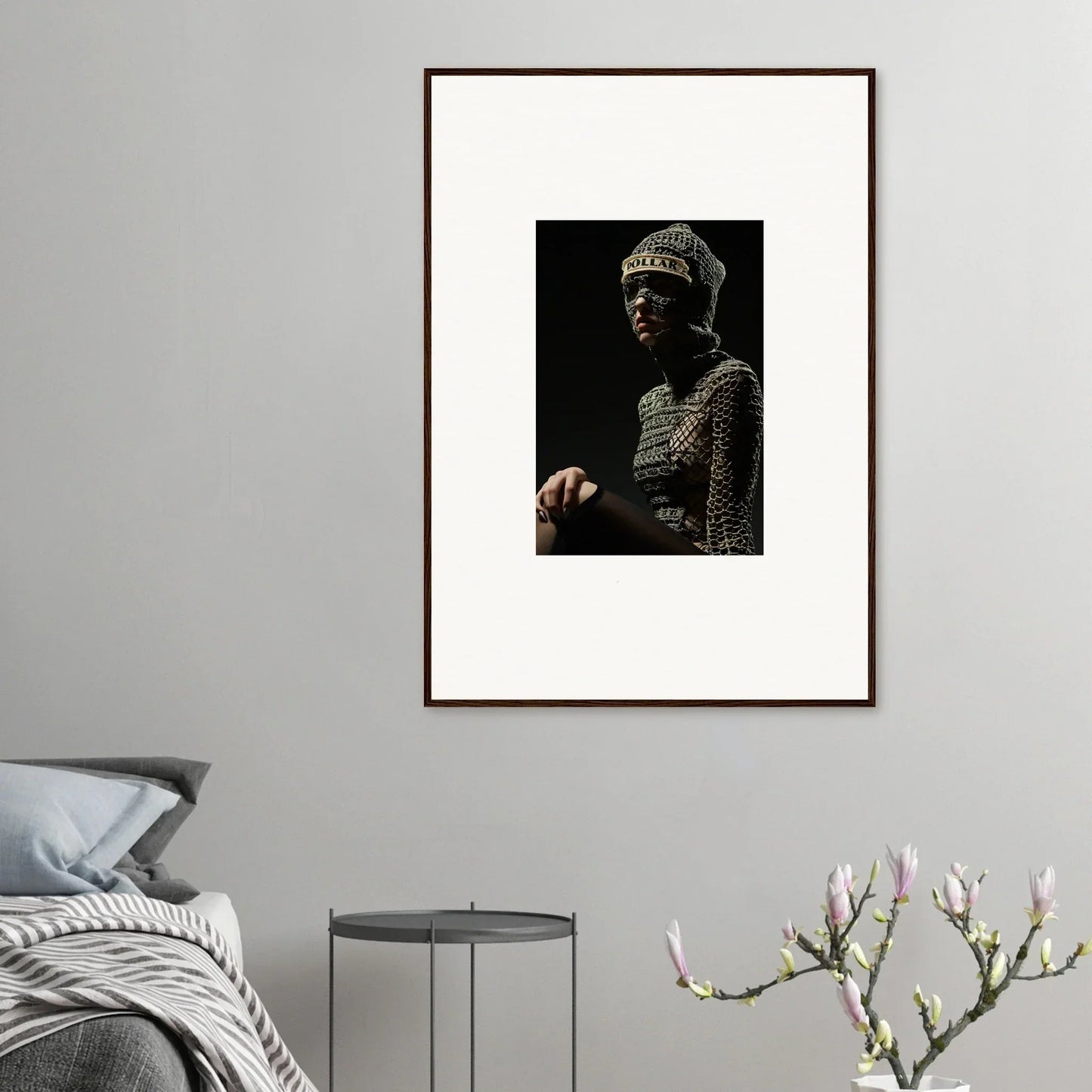 Framed portrait photograph of a person wearing chainmail armor and a helmet.