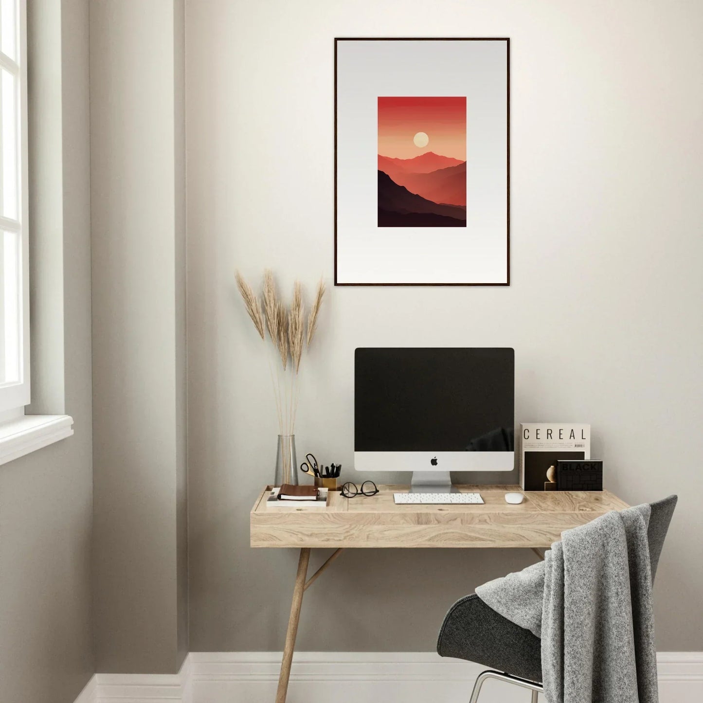 Minimalist home office with wooden desk, computer, and canvas print of crimson vibrations