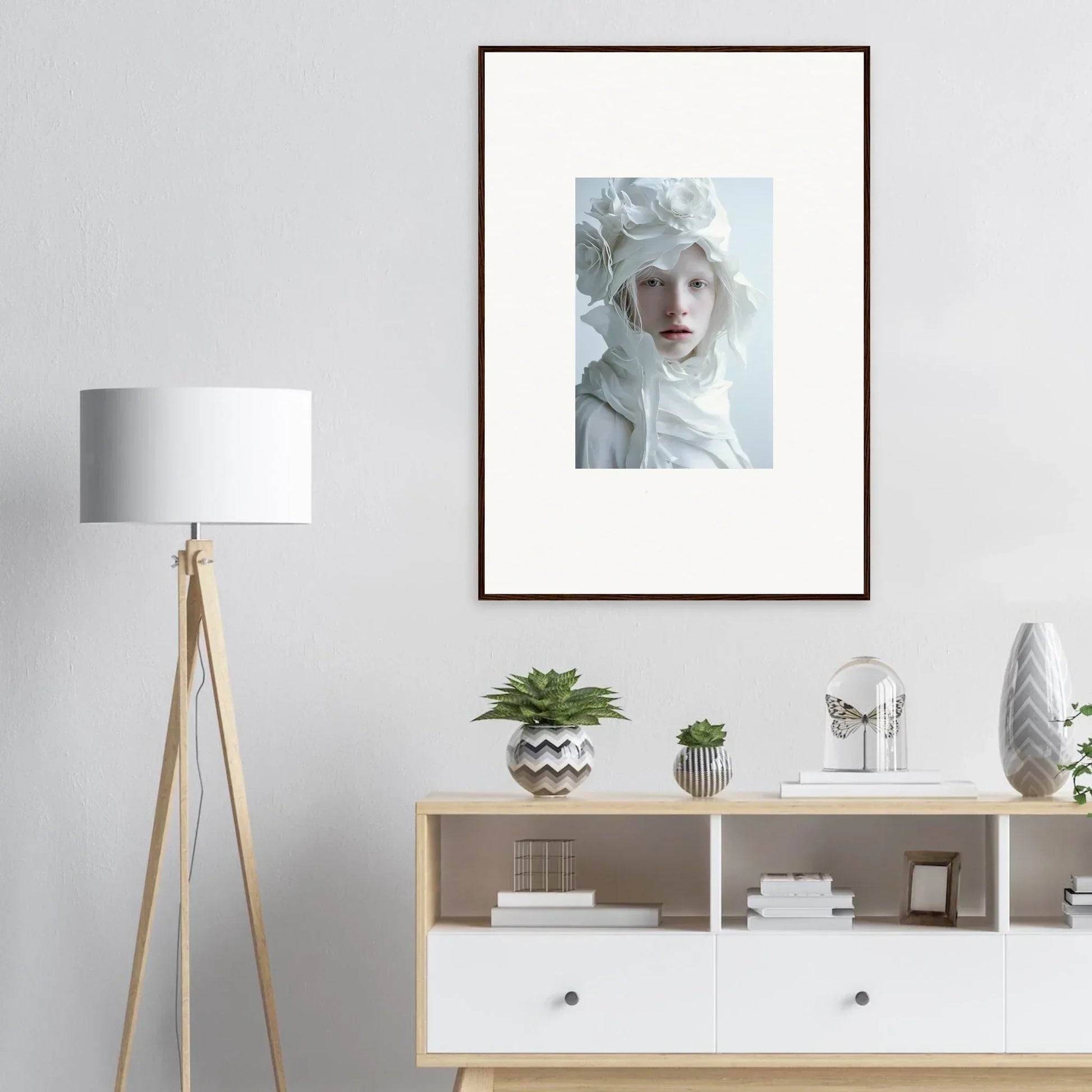Framed wall art of a person with pale features and white fabric, ideal room decor