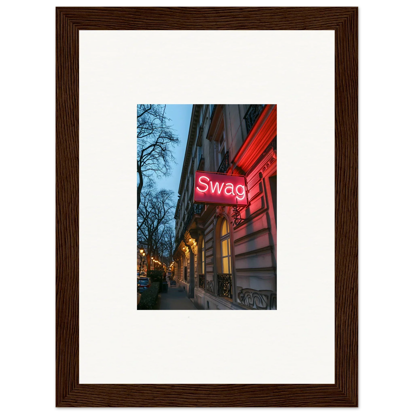 Framed wall art of a neon Swag sign on a building at dusk for timeless room decor