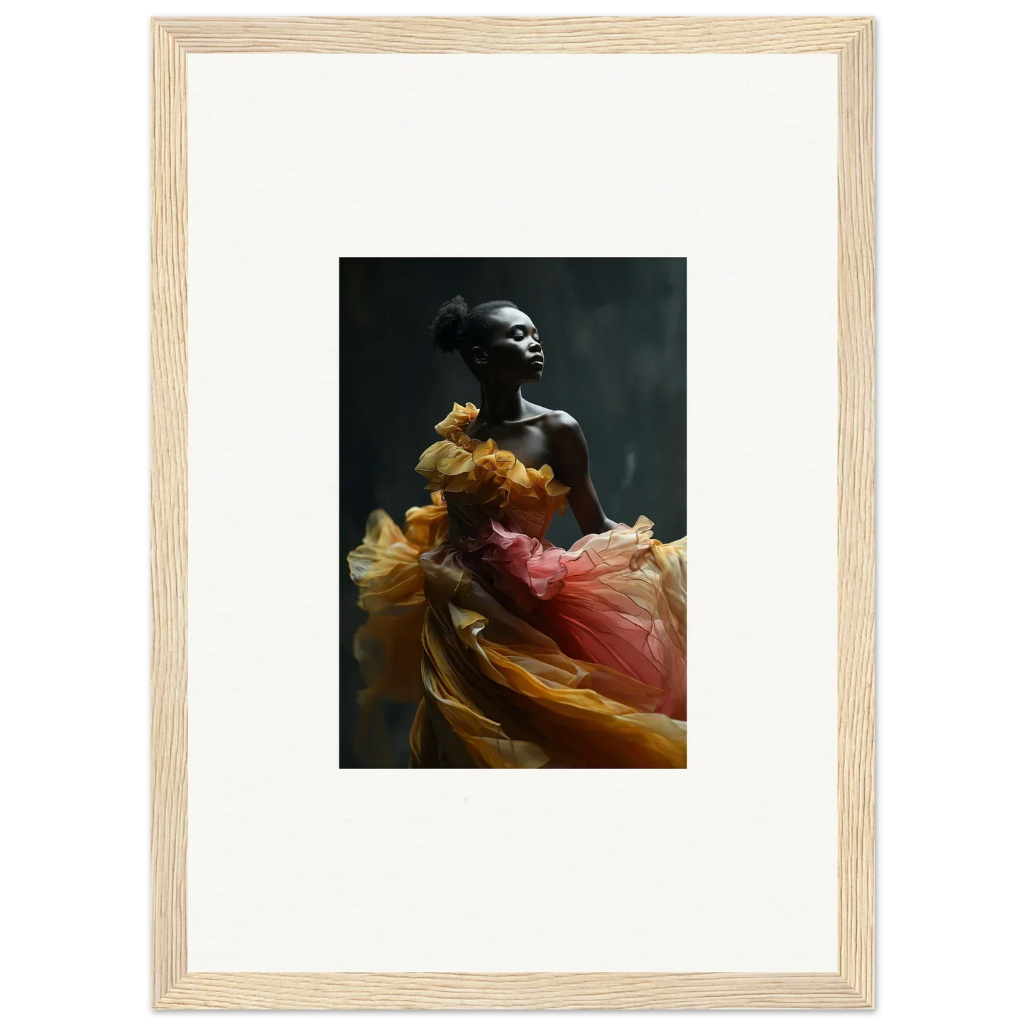 Framed black-and-white photograph of a person draped in flowing, colorful fabric.