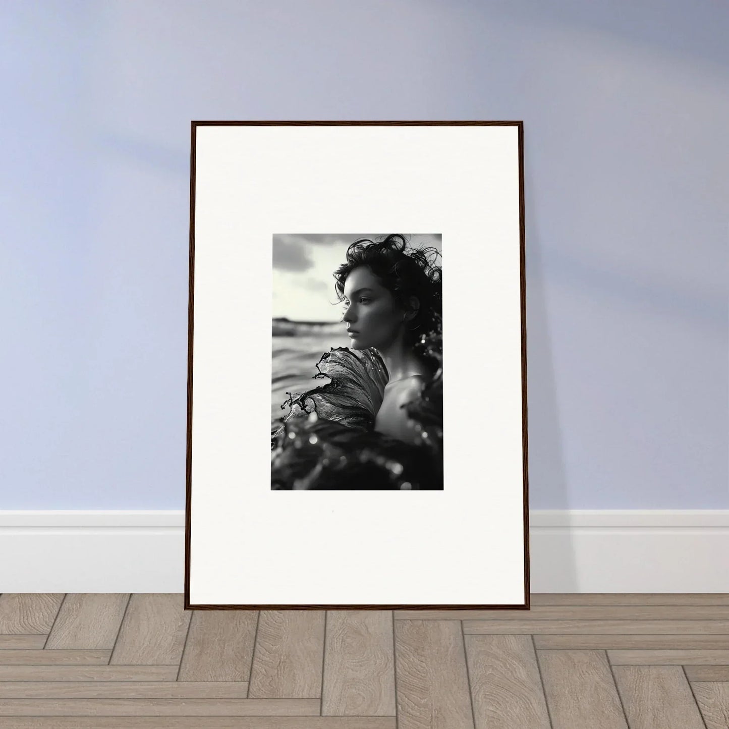 Framed black and white canvas print of a windswept person for sea reverie room decoration