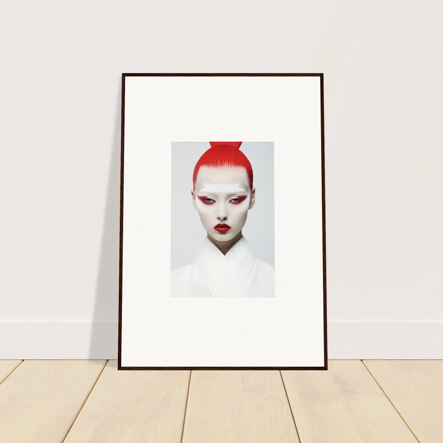 Framed wall art featuring a person with bright red hair against a white background