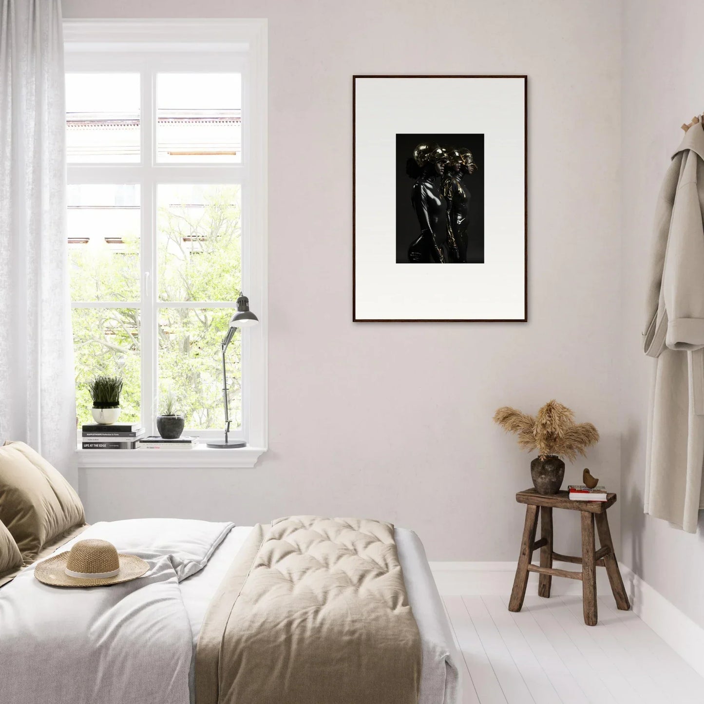 Cozy bedroom with neutral decor and a framed black and white artwork on the wall.