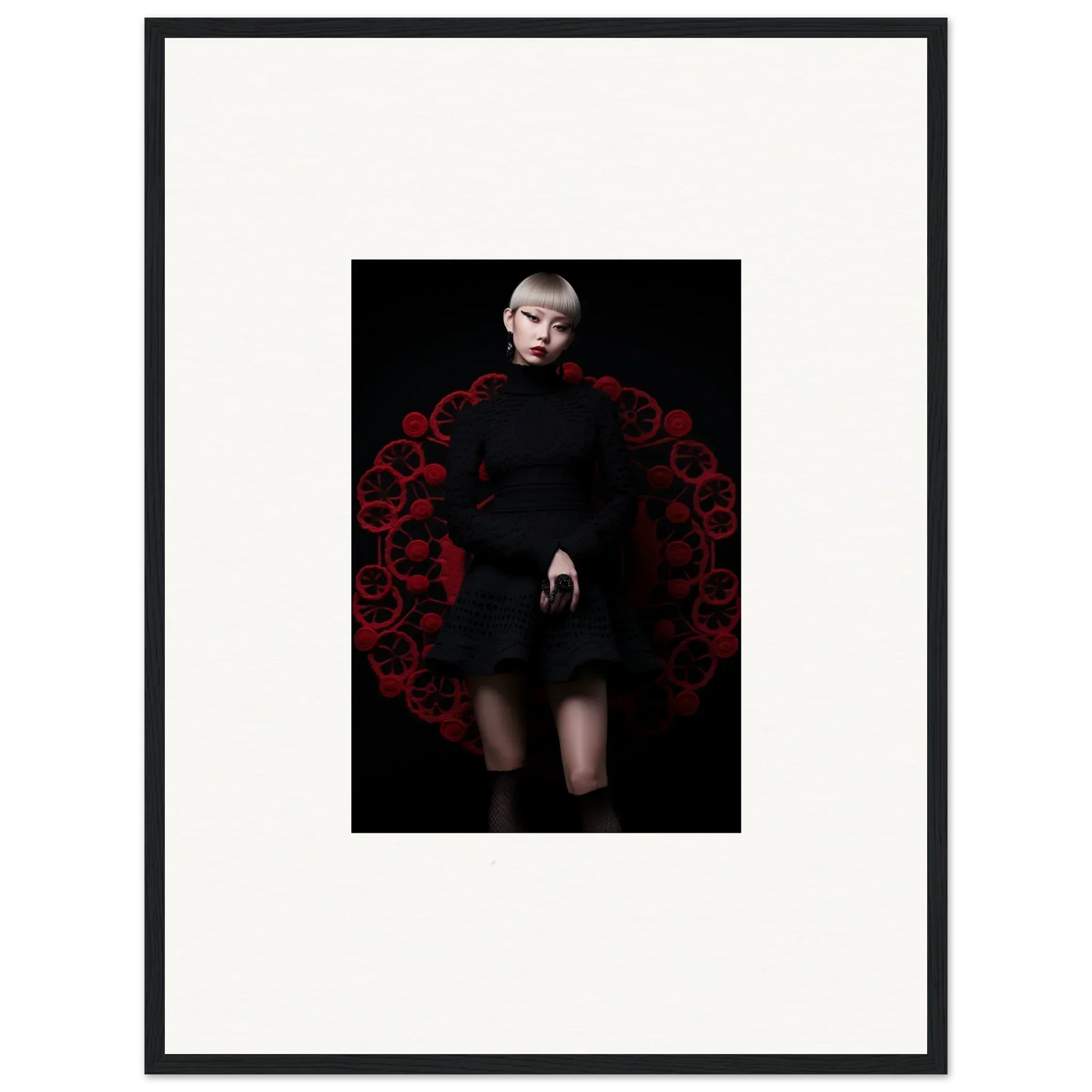 Dramatic fashion shot of Obsidian Lace Waltz black dress with red floral arch