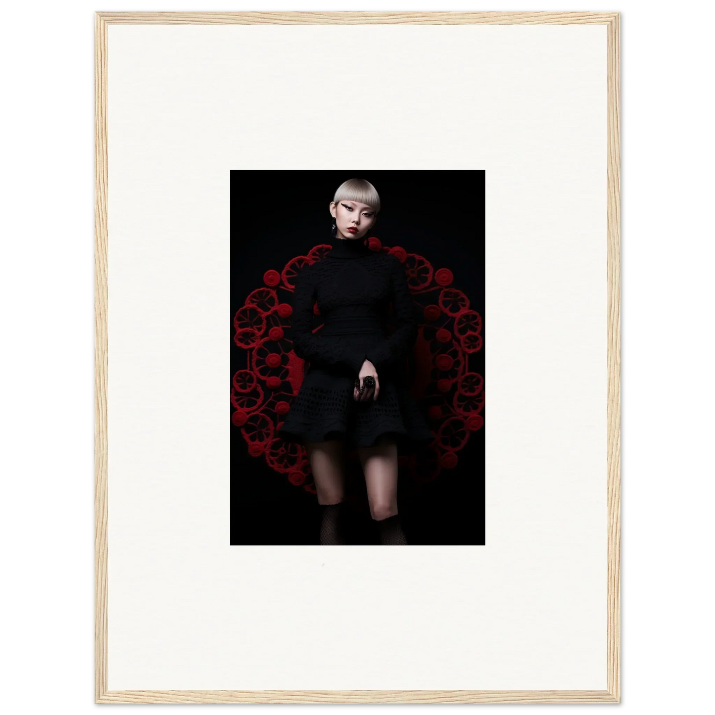 Dramatic Obsidian Lace Waltz dress framed by a lush red floral arch in stunning fashion
