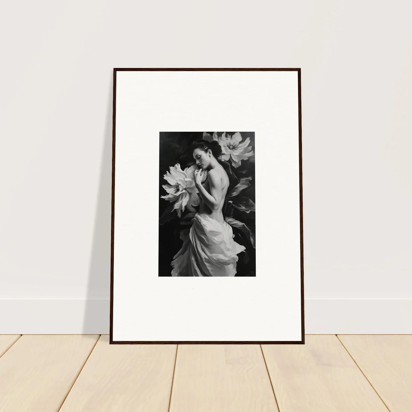 Framed black and white wall art of a woman in a flowing dress and large flowers for room decor