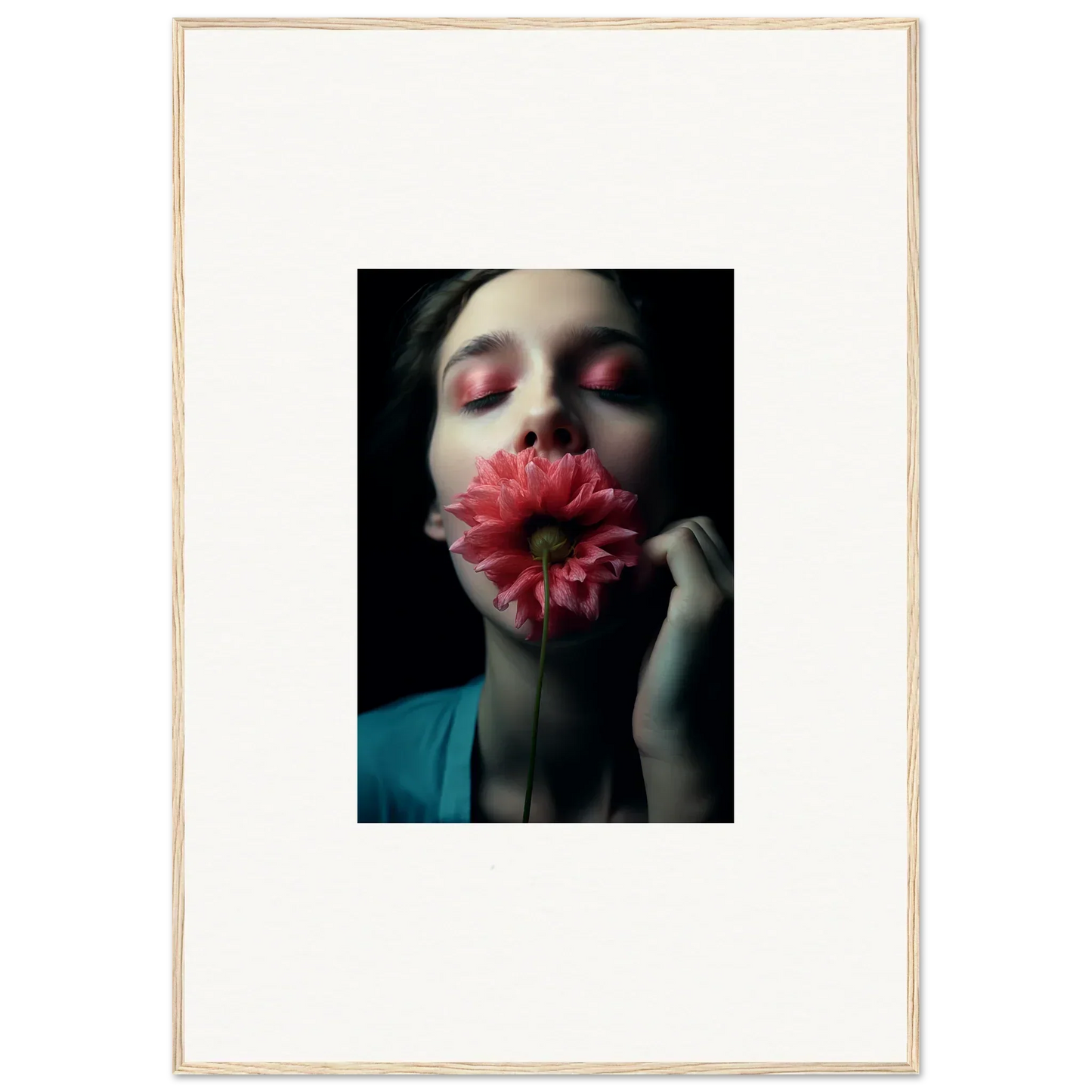 Portrait of a person in teal holding a pink gerbera daisy for wall art inspiration