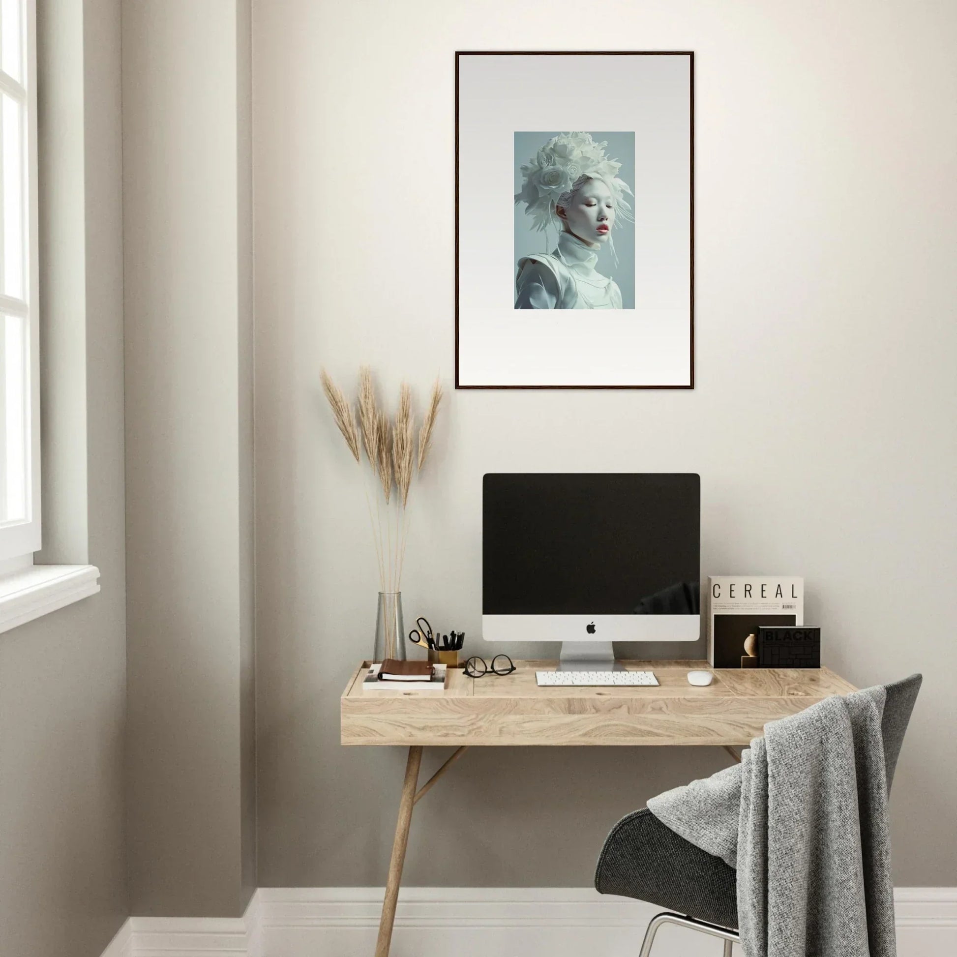 Minimalist wooden desk with computer and blossoms rising canvas print above